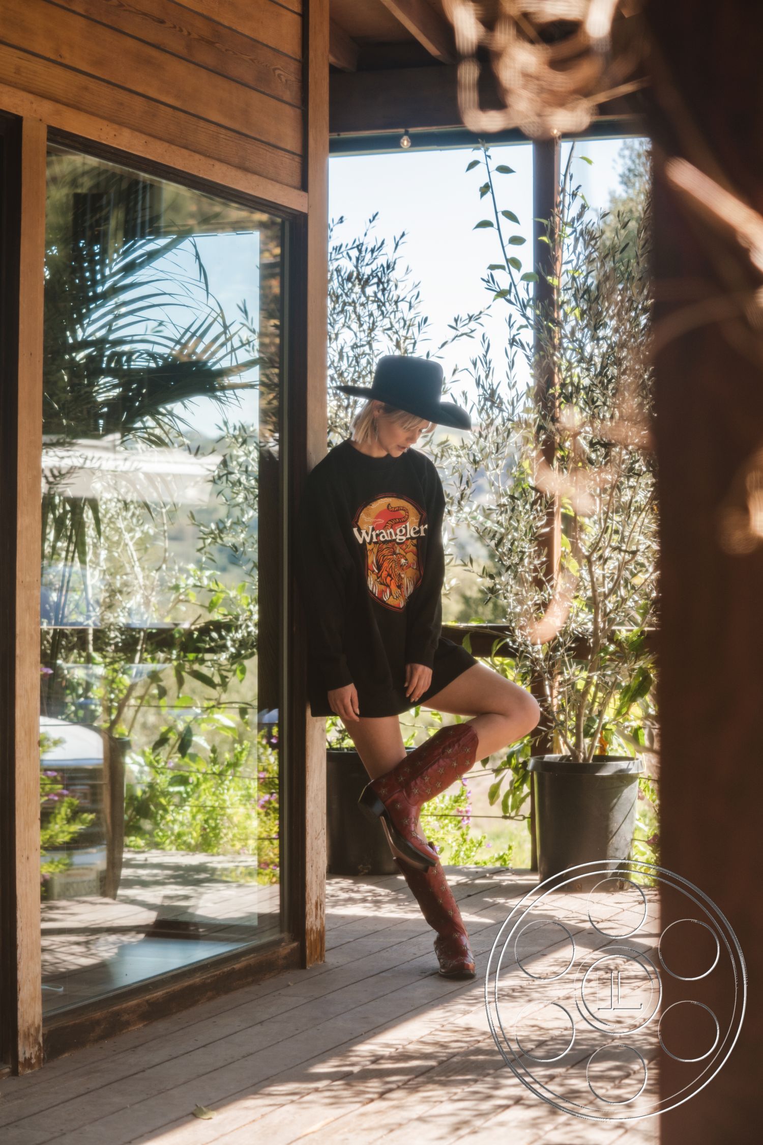 Topanga Retreat - natural wood flooring, floor-to-ceiling windows, open concept living space, modern farmhouse aesthetic, textured wood ceiling, sloped roof design, surrounding lush greenery, minimalist furniture arrangement, interior wooden wall paneling, exterior large glass sliding doors, rustic wood beam accents, sunlit indoor garden area, contemporary outdoor deck, stylish cowboy boots aesthetic, casual contemporary fashion style