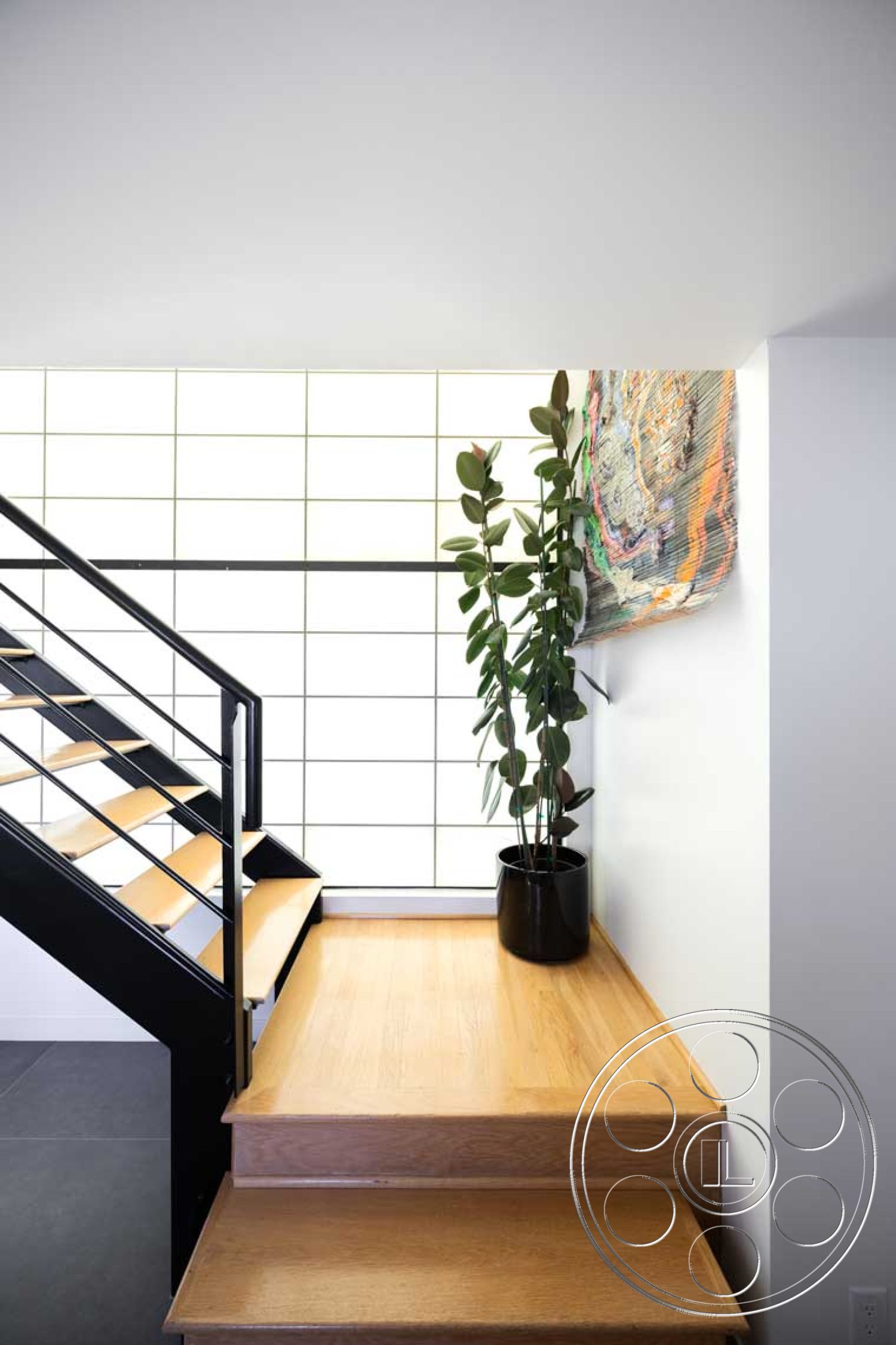 Modern 56 - textured wall art, open concept design, modern architectural style, indoor plant decor, white painted walls, minimalist interior, black metal stair railings, interior hardwood staircase, light oak stair treads, grid-pattern window wall