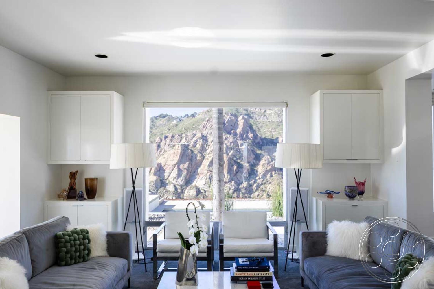 Modern 56 - minimalist decor, indoor plants, glass coffee table, modern lighting fixtures, floor-to-ceiling windows, white cabinetry, vaulted ceiling, mountain view, bright white walls, light gray sectional sofa, contemporary art piece, interior living room, textured carpet flooring, natural light filled space, white modern armchairs, decorative green throw pillow