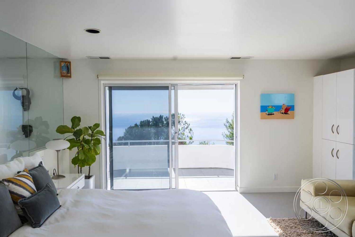 Modern 56 - neutral color palette, minimalist design, open layout, modern furniture, glass sliding doors, floor-to-ceiling windows, decorative wall art, bright natural lighting, textured throw pillows, plush area rug, concrete patio flooring, white painted walls, interior bedroom with ocean view, potted green indoor plant, built-in bedroom cabinets, corner sectional sofa