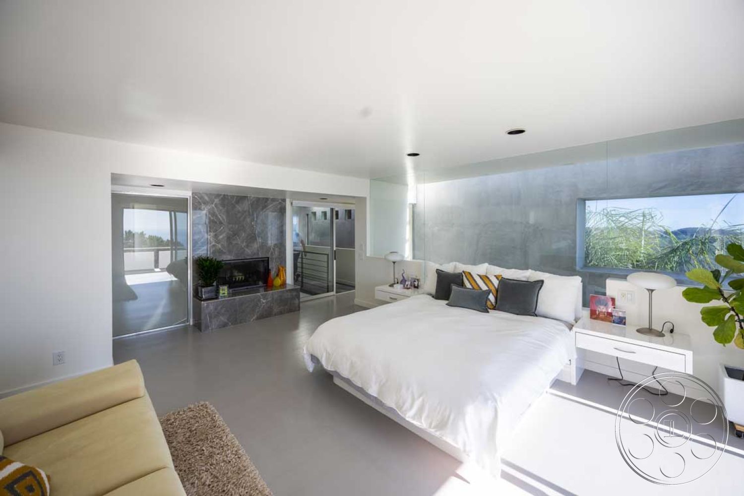 Modern 56 - neutral color palette, plant decor, open floor plan, concrete flooring, modern lighting fixtures, sliding glass doors, floor-to-ceiling windows, steel railing, king-sized bed, plush area rug, white plaster walls, built-in cabinetry, view of outdoor space, marble fireplace surround, minimalist bedroom design, paneled glass wall, contemporary nightstands, textured wall accent, sunlight-filled room