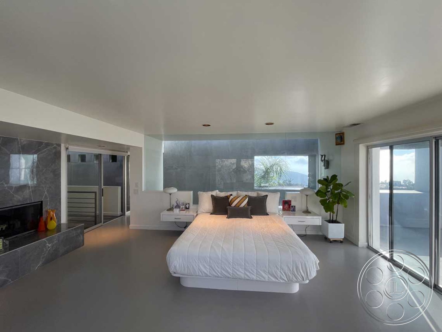 Modern 56 - neutral color palette, open floor plan, polished concrete flooring, floor-to-ceiling windows, natural light from large windows, marble feature wall, contemporary lighting fixtures, interior bedroom, glass sliding door to outdoor space, modern fireplace surround, minimalist white decor, modern floating nightstands, luxury bedding with accent pillows, geometric planter with indoor plant, angular architectural elements