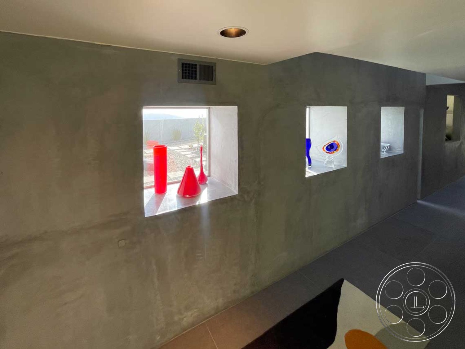 Modern 56 - neutral color palette, open space layout, minimalist architectural design, exposed concrete walls interior, contemporary interior decor, textured concrete finish, clean lines in architecture, modern interior lighting fixtures, small square window openings, concrete floor tiles interior, bright colored decorative items, natural light through window openings, streamlined form interiors, square geometric shapes, functional indoor display areas