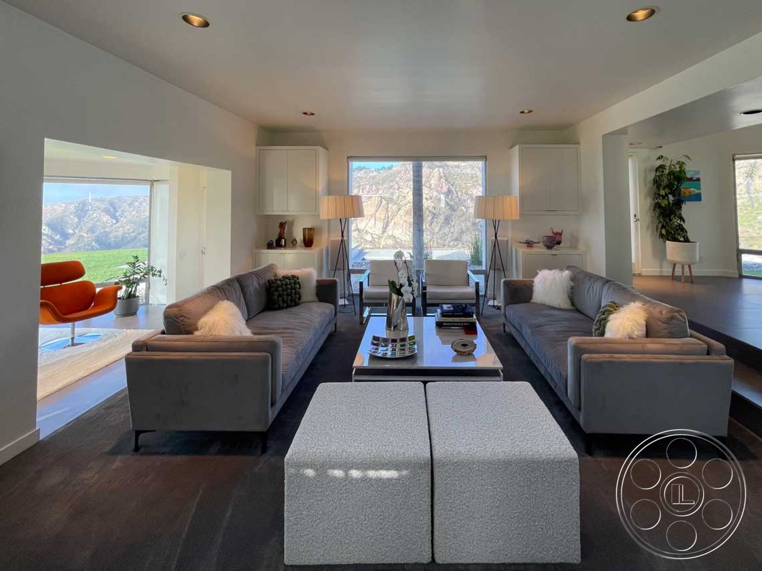 Modern 56 - minimalist decor, recessed lighting, neutral wall colors, indoor plants, textured area rug, open floor plan, glass coffee table, concrete flooring, floor-to-ceiling windows, mountain view, soft lighting fixtures, plush throw pillows, exposed wood ceiling beams, interior living room, contemporary art pieces, modern accent chair, modern sectional sofas, suede upholstery