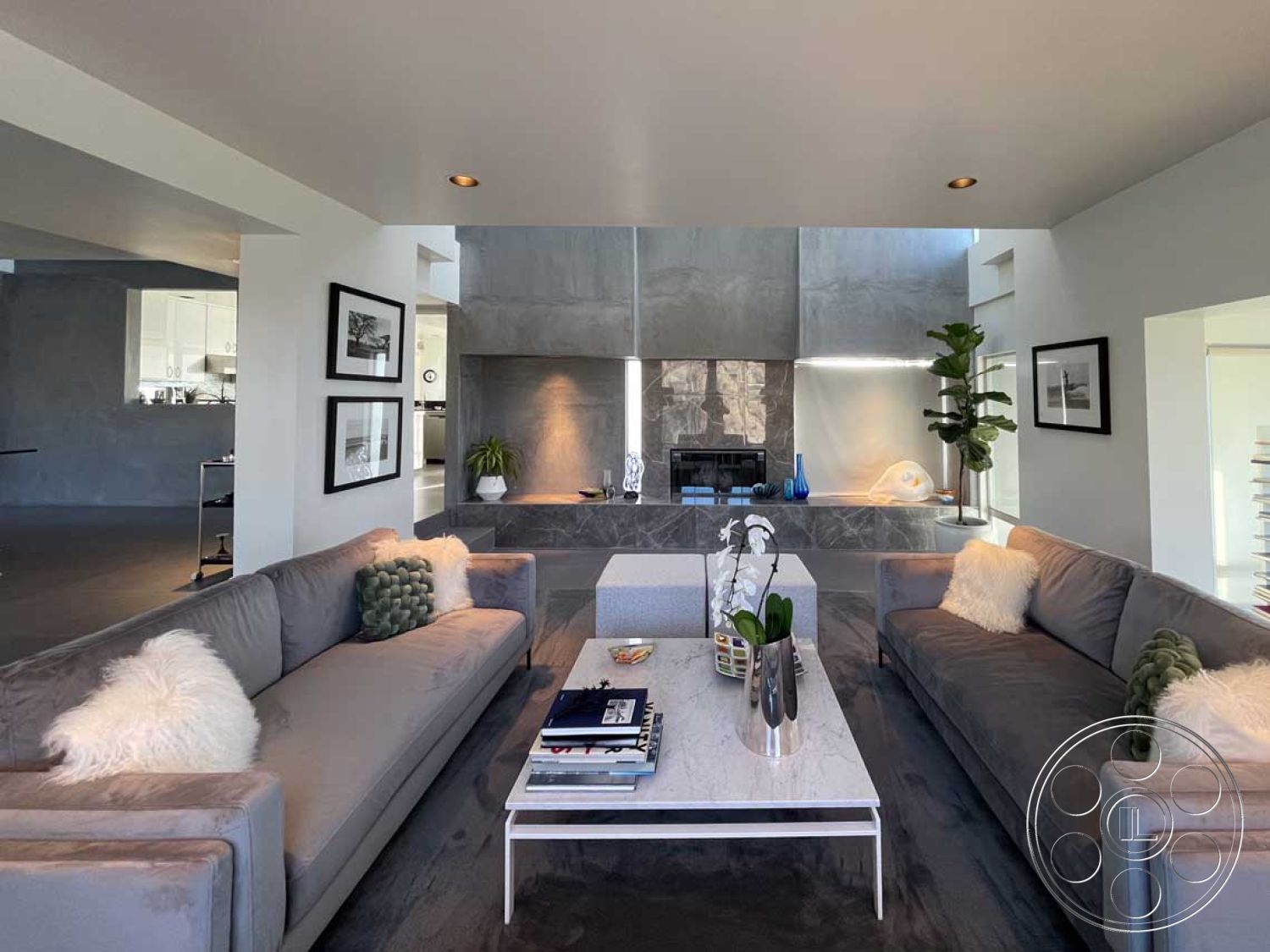 Modern 56 - neutral color palette, exposed concrete walls, textured wall treatment, contemporary architectural style, recessed lighting fixtures, modern fireplace surround, minimalist furniture design, open floor plan living area, living room seating area, smooth concrete ceiling, large glass windows for natural light, cozy sectional sofa, sculptural decor elements, greenery accents with potted plants, marble coffee table with metal base, grey hardwood living room floors, built-in decorative shelves, artistic wall art frames, soft fur throw pillows