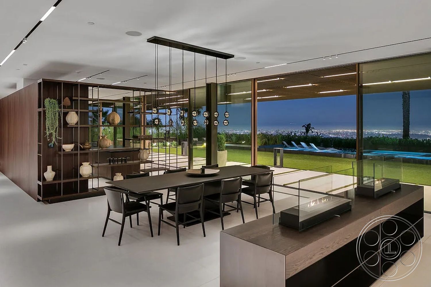 Modern 517 - concrete flooring, modern pendant lighting, wooden dining table, rectangular swimming pool, outdoor lounge area, large floor-to-ceiling windows, built-in cabinetry, contemporary architectural style, black metal dining chairs, interior open floor plan, minimalist fireplace design, glass wall with outdoor view, wood accent wall with shelving, lush green outdoor landscaping, city skyline view at night, smooth concrete wall surface, textured ceiling with integrated lighting