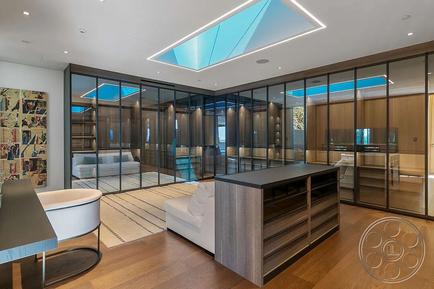 Modern 517 - neutral color palette, open concept layout, contemporary furnishings, decorative wall art, black quartz countertop, modern minimalist design, interior hardwood flooring, interior skylights, natural light abundance, exposed wood cabinetry, living room seating area, exterior glass partition walls, interior flat ceiling with recessed lighting, modern accent rug, functional home office setup