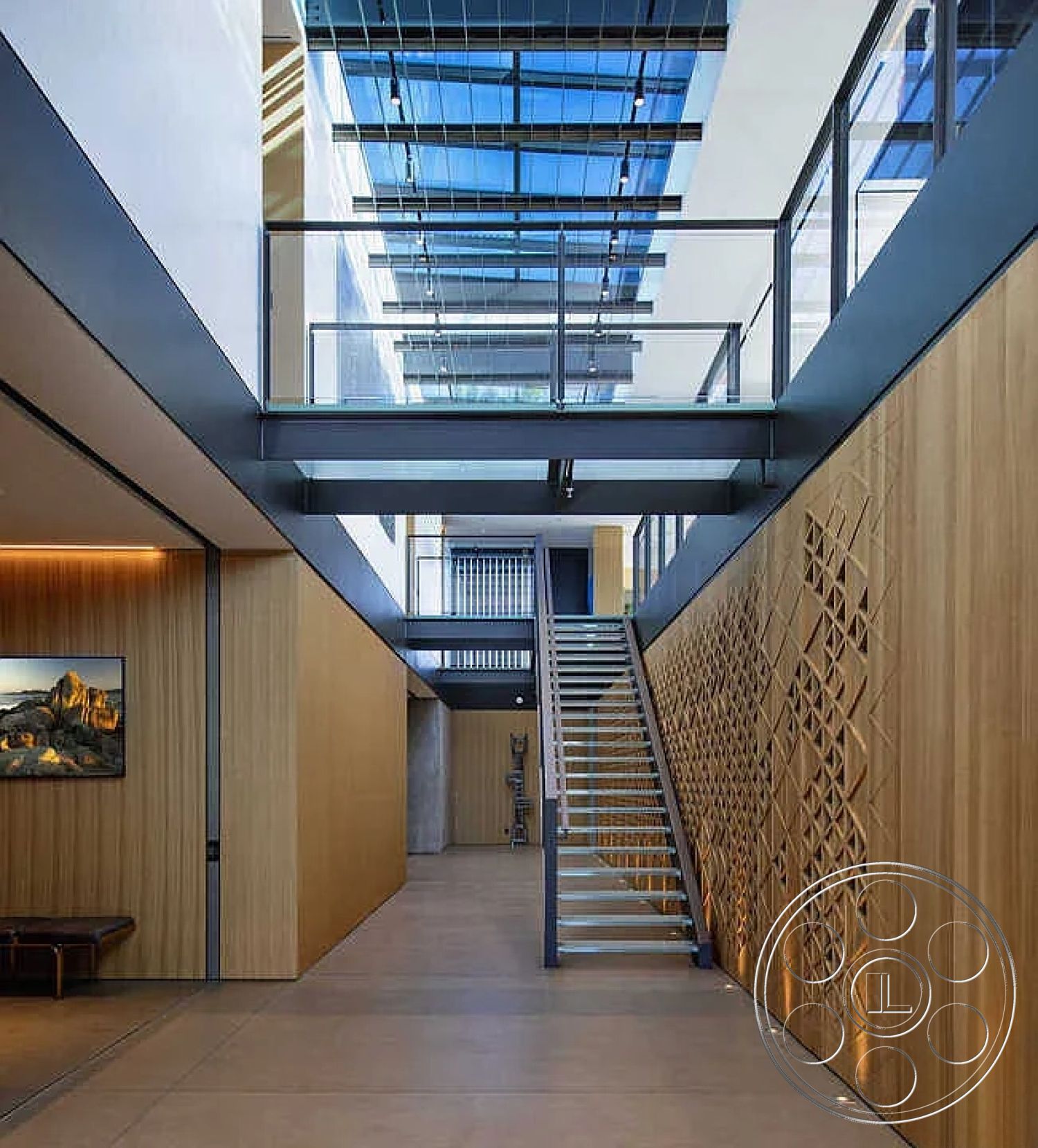 Modern 517 - neutral color palette, acoustic ceiling panels, minimalist architectural design, glass balcony railing, interior wood paneling walls, high ceiling with skylights, modern open concept layout, industrial style elements, concrete floor tiles, natural light-filled interior, decorative artwork on walls, exposed metal staircase, geometric wood wall treatment, large entryway space, suspended staircase design