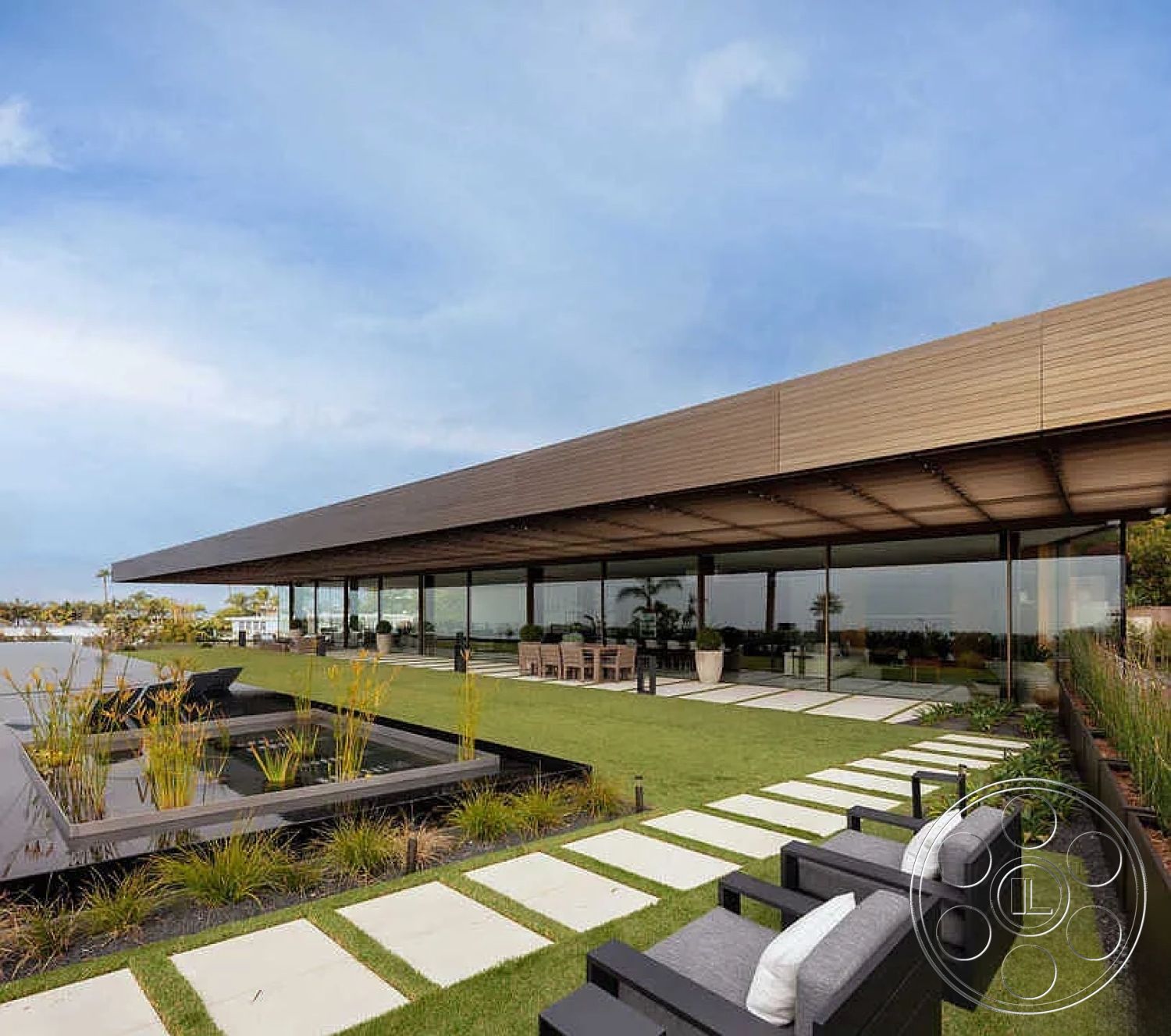 Modern 517 - exterior, minimalist design elements, modern landscaping, urban setting, city skyline view, luxurious outdoor space, contemporary outdoor seating, metal planters, concrete patio flooring, open-air dining area, rectangular water feature, glass wall facade, wood slat overhang, slate stepping stones, low-maintenance grass, linear garden beds, sharp angles in architecture, horizontal lines in structure, modern residential home