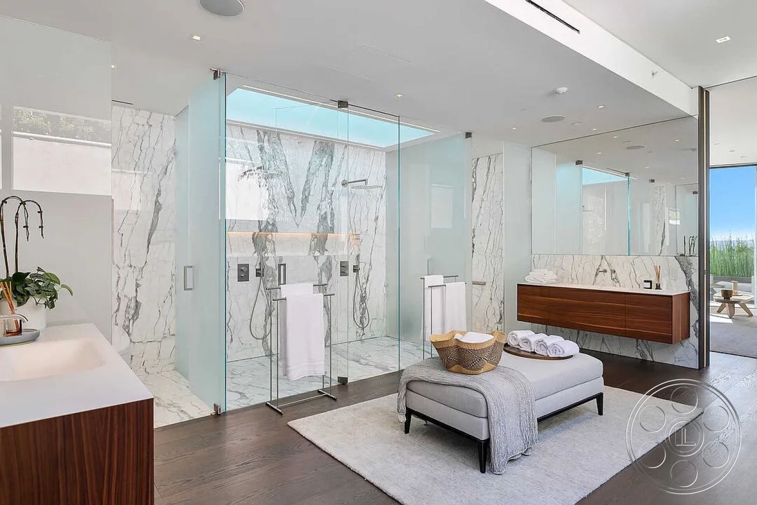 Modern 517 - interior neutral color palette, interior natural light from windows, interior recessed lighting fixtures, interior marble bathroom walls, interior marble shower walls, interior glass shower doors, interior contemporary bathroom design, interior open space layout, interior wall-mounted faucets, interior hardwood flooring in bathroom, interior floating vanity with wood finish, interior modern bathroom sink, interior large mirror with reflection, interior towel storage rack, interior soft textile accessories