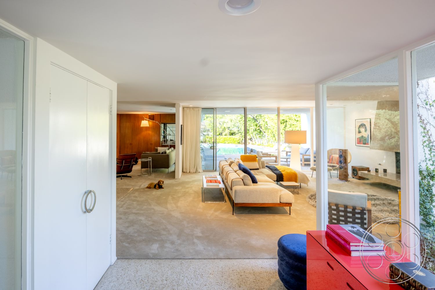 MCM 27 - interior, terrazzo flooring, modern living room, interior, white painted walls, minimalist design, interior, wood panel accent wall, warm tone, interior, floor-to-ceiling glass windows, natural light, interior, open-concept layout, seamless flow, interior, contemporary furniture design, clean lines, interior, plush area rug, soft texture, interior, built-in shelving units, functional storage, interior, recessed lighting, ambient illumination, interior, sectional sofa, spacious seating, interior, artistic wall decor, contemporary art, interior, curtain window treatments, privacy solution, interior, coffee table styling, modern accessories, interior, decorative accent pillows, vibrant colors, interior, stylish floor lamp, statement lighting, interior, stylish credenza, sleek storage, exterior, lush greenery view, natural environment, exterior, swimming pool area, outdoor living, exterior, sliding glass doors, easy access, exterior, patio seating arrangement, relaxation spot