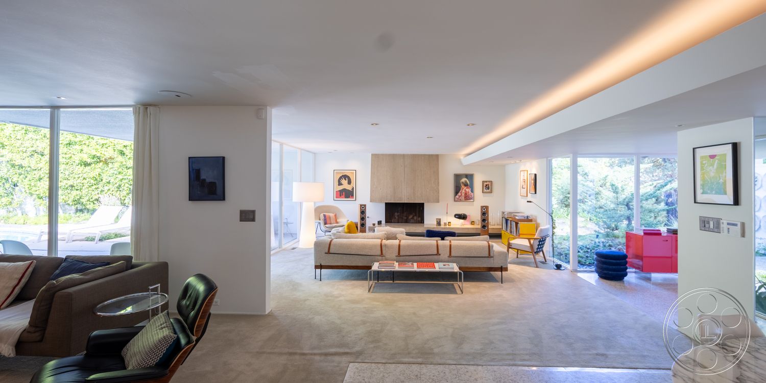 MCM 27 - neutral color palette, cozy seating arrangement, modern lighting fixtures, minimalist furnishings, decorative wall art, open-concept layout, stylish accent chairs, vibrant color accents, outdoor garden view, light wood ceiling beams, textured plaster wall finish, open floor plan design, floor-to-ceiling glass windows, multifunctional living area, exposed concrete interior walls, concrete fireplace surround, plush carpet living room flooring, contemporary Art Deco accents, modern wood panel feature wall, luxurious fabric upholstery, functional layout for gatherings