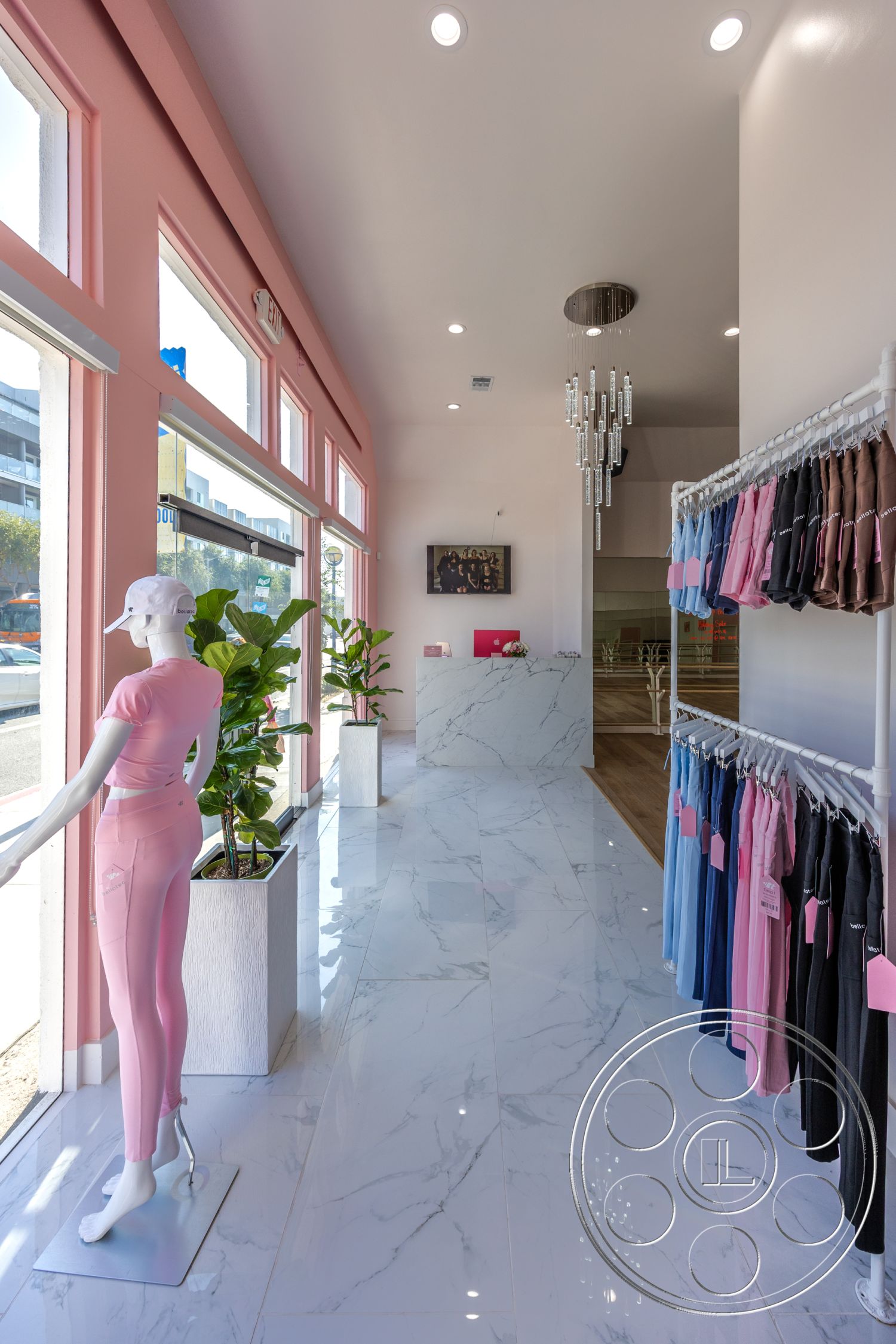 Gym 37 - minimalist design, open floor plan, polished marble flooring, accent art piece, decorative indoor plants, LED recessed lighting, large storefront windows, smooth ceiling finish, marble tile flooring, chandelier lighting fixture, modern retail display, soft pink accent walls, hanging clothing racks, white planter boxes, grey stone feature wall, wooden reception counter