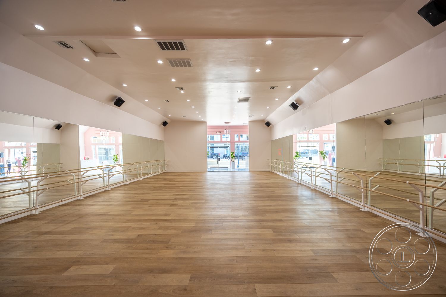 Gym 37 - interior recessed lighting, interior white painted walls, interior minimalist design, interior open layout, interior large windows with city view, interior hardwood dance studio floor, interior mirrored wall treatment, interior ballet bar railings, interior acoustic ceiling panels, interior smooth plaster wall finishes