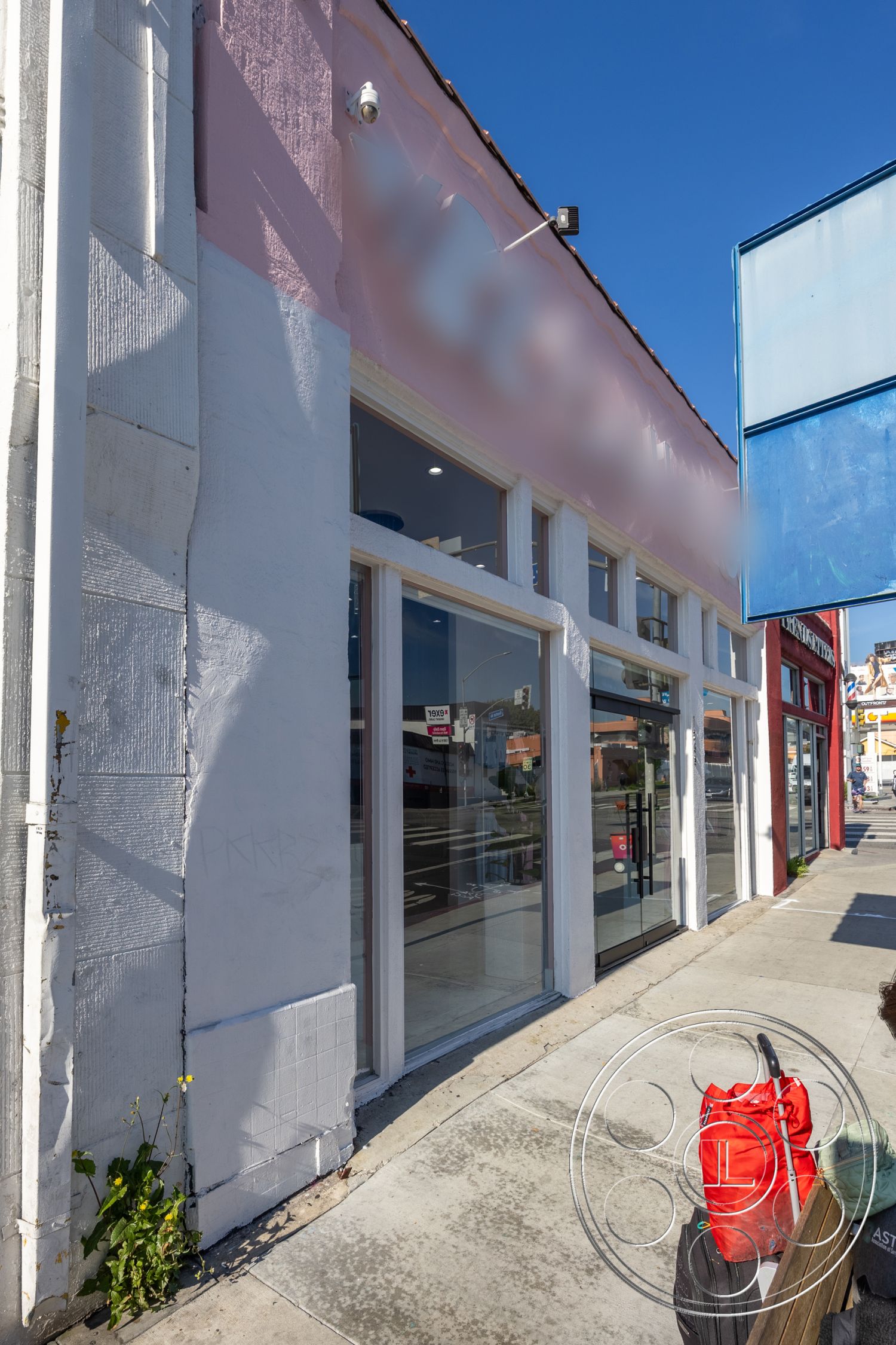 Gym 37 - exterior, textured concrete wall, concrete sidewalk, stucco wall finish, commercial building design, glass storefront windows, urban streetscape, pink exterior paint, black metal door frame, open signage display, adjacent store fronts, neighborhood setting, city surroundings, casual urban environment