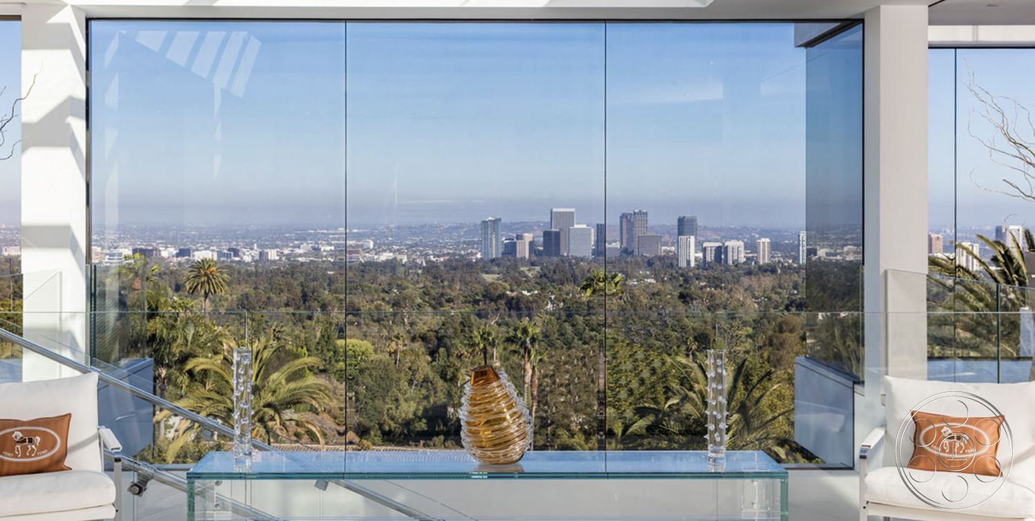 Modern 518 - neutral color palette, polished concrete floor, large floor-to-ceiling windows, minimalist furniture design, stylish accent decor, interior glass walls, exterior city skyline view, exterior mountain view, bright natural light interior, transparent glass coffee table, modern glass railing, contemporary open layout, luxury modern living room, tasteful decorative accents