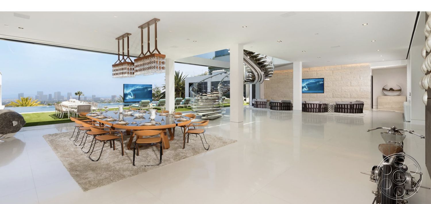 Modern 518 - interior natural light, interior area rug, interior floor-to-ceiling windows, interior open floor plan, interior contemporary furniture, interior polished concrete flooring, interior stone accent wall, interior decorative wall art, exterior landscaping with palm trees, interior glass wall, interior modern chandelier, exterior patio furniture, interior spiral staircase, exterior mountain backdrop, interior wooden dining chairs, exterior swimming pool view, exterior balcony with city skyline view, interior multi-functional dining area