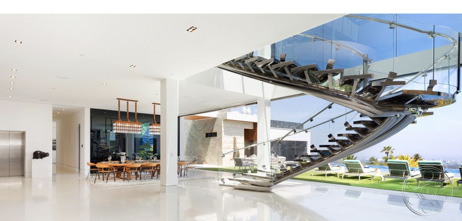 Modern 518 - minimalist design elements, modern architectural style, open concept living space, glass railing staircase, contemporary light fixtures, white painted walls, interior polished concrete flooring, natural light from floor-to-ceiling windows, modern dining area with wooden table, exposed wood floating staircase, stylish kitchen with integrated appliances, luxury interior space with ocean view, plush area rug under dining table, elevated ceiling with recessed lighting, outdoor seating area with lounge chairs, landscaped garden pool area