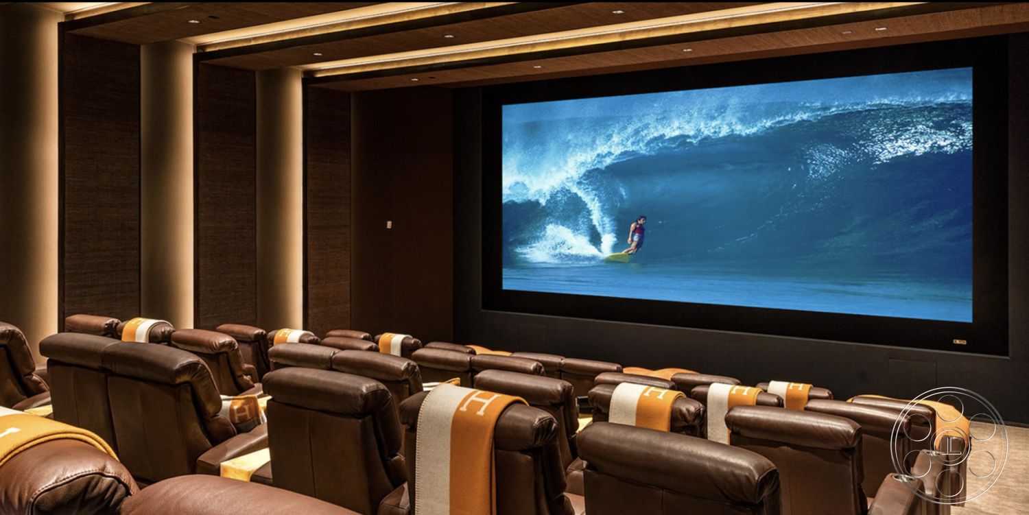 Modern 518 - spacious layout, carpet flooring, large projection screen, modern minimalist design, acoustic ceiling panels, dark wood paneling walls, coffered ceiling details, blackout curtains, interior home theater, reclining leather theater seats, soft LED ambient lighting, luxury entertainment room, built-in sound system