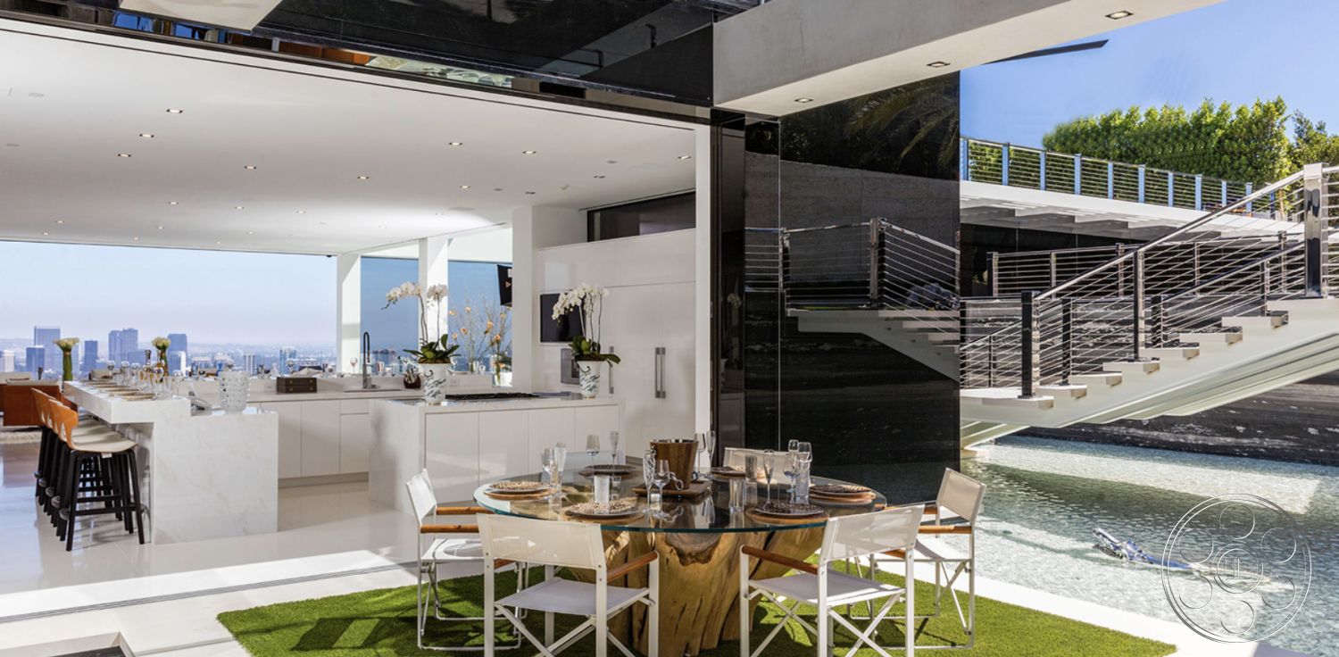 Modern 518 - stainless steel appliances, polished concrete flooring, minimalist design elements, exposed concrete walls, floor-to-ceiling windows, white cabinetry, outdoor dining area, city skyline view, steel railings, floating staircase, luxury pool view, natural light emphasis, marble kitchen island, modernist architectural style, glass wall partition, open concept interior, landscaped patio, chef's kitchen layout, green grass accent