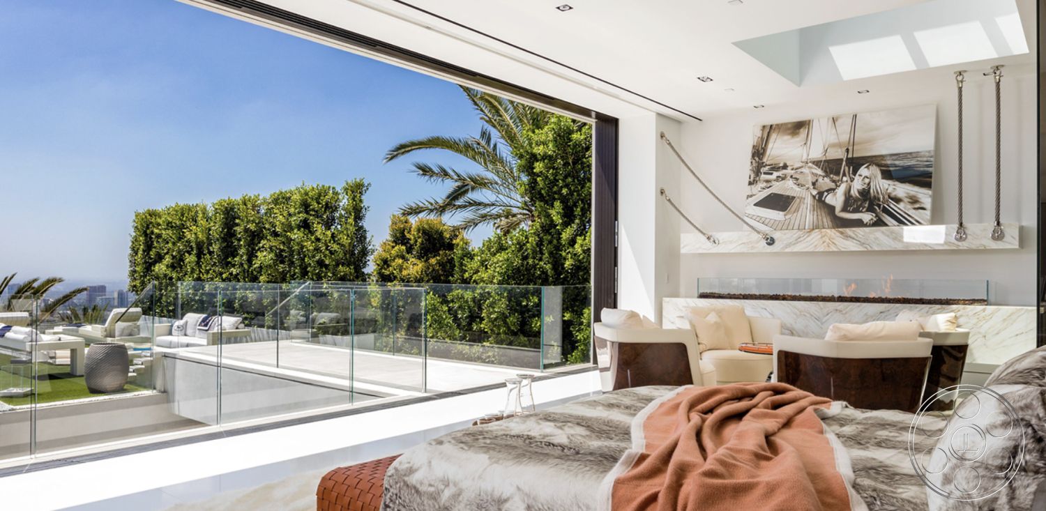 Modern 518 - glass sliding doors interior, open floor plan interior, natural light-filled space interior, minimalist design aesthetic interior, modern fireplace feature interior, marble accent wall interior, contemporary furniture arrangement interior, hardwood bedroom flooring interior, luxury master bedroom interior, landscaped garden view exterior, glass railing balcony exterior, pool area view from bedroom interior, textured fabric throw blanket interior, large windows with scenic view interior, white walls with art decor interior, outdoor living area exterior, palm tree landscape exterior, heating fireplace design interior