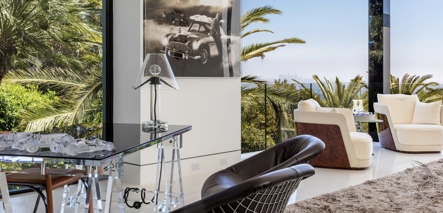 Modern 518 - minimalist decor, hardwood flooring, open floor plan, framed wall art, plush area rug, palm tree view, contemporary lighting fixture, dark wood accent table, interior modern living room, luxury home environment, glass wall view, acrylic dining table, white leather lounge chairs, city skyline beyond greenery