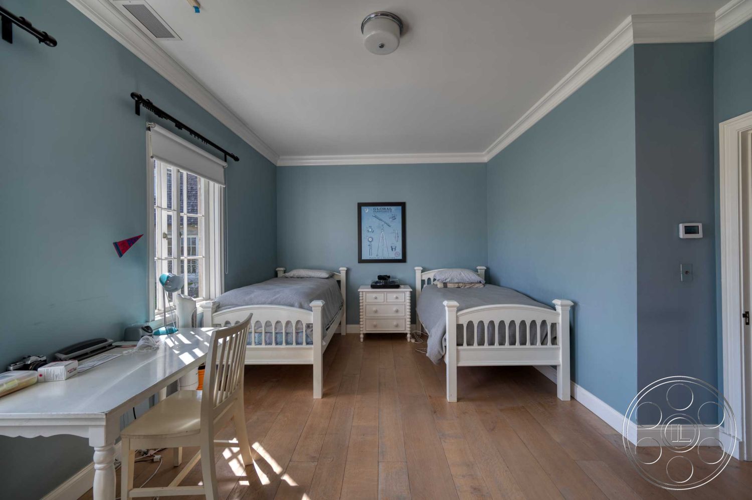 The French Chateau - desk with chair, floor-to-ceiling windows, light fixtures, two twin beds, interior bedroom, hardwood bedroom floors, white painted walls, crown molding details, blue wall decor