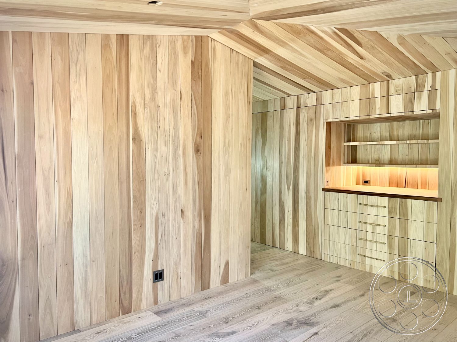 Zen Garden - minimalist design, cozy atmosphere, light hardwood flooring, warm wood tones, modern aesthetic, organic materials, under-cabinet lighting, wood beam ceiling, open floor layout, decorative wood accents, built-in wood cabinetry, textured wood surfaces, natural wood paneling walls