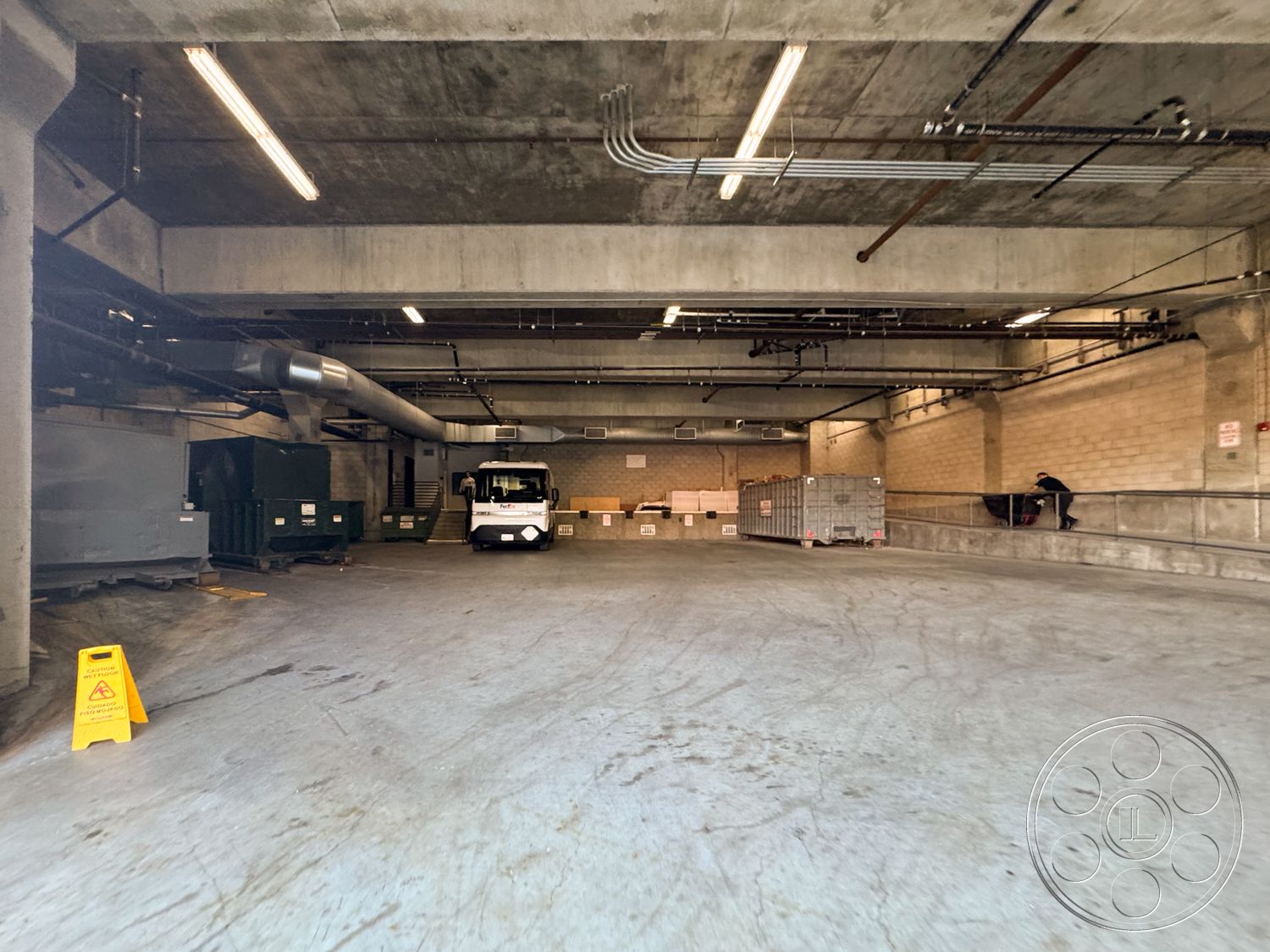 Sunset Storefront - high ceilings, open space layout, minimalist design elements, exposed concrete walls, utility area, floor-to-ceiling windows, industrial lighting fixtures, contemporary aesthetic, textured concrete surface, modern industrial design, urban interior, metal ceiling beams, concrete floor parking area, steel venting ducts, brick feature wall, functional warehouse space, loading dock area, concrete construction materials