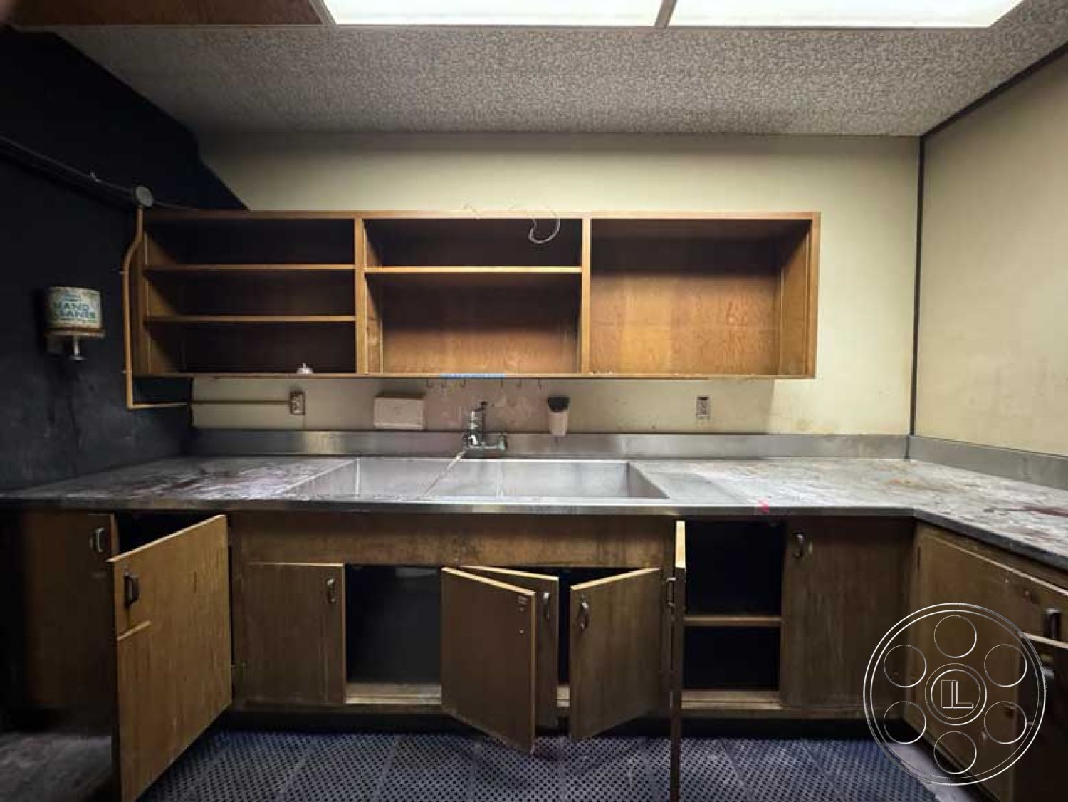 Old School - tile flooring, wood cabinetry, concrete countertop, interior kitchen space, exposed plumbing fixtures, stainless steel kitchen sink, minimalist kitchen layout, textured ceiling tiles, functional work area, open shelving units, industrial kitchen design, black wall paint, metallic cabinetry handles, modern utility kitchen