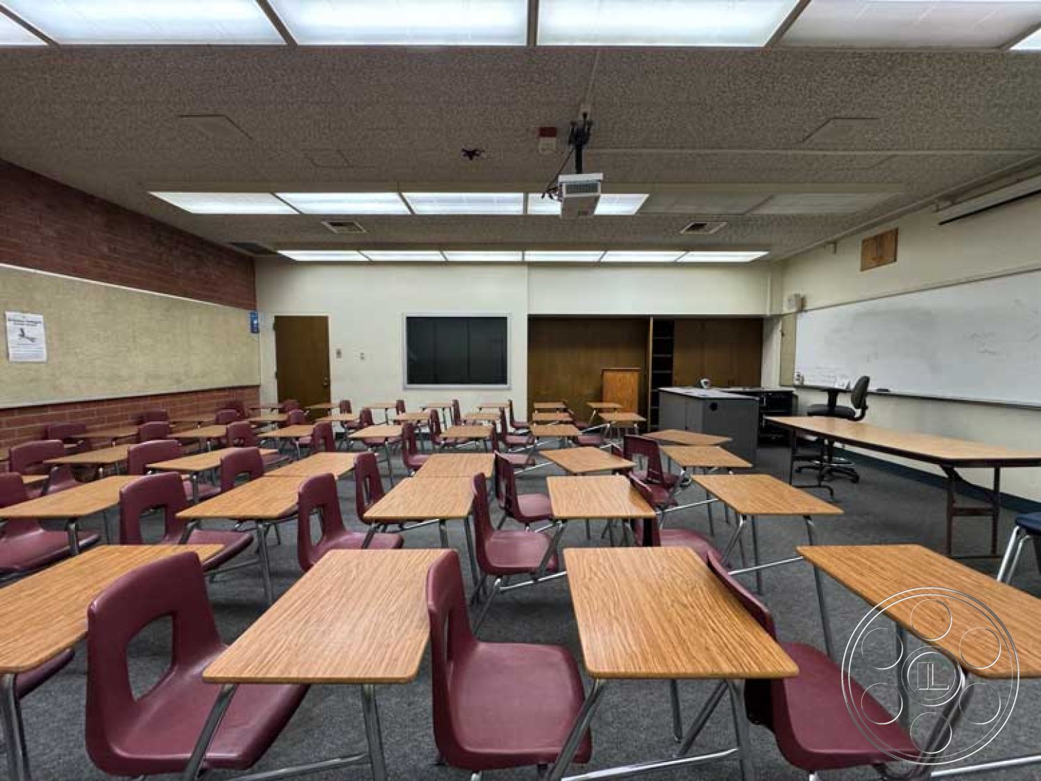 Old School - blackboard wall, drop ceiling with fluorescent lighting, brick accent wall interior, plastic classroom chairs, wall-mounted whiteboard, neutral-colored walls, square classroom layout, wood laminate classroom flooring, foldable classroom desks, projector mount ceiling, bookcase storage unit, glass-paneled classroom window, carpeted classroom floor, educational environment interior