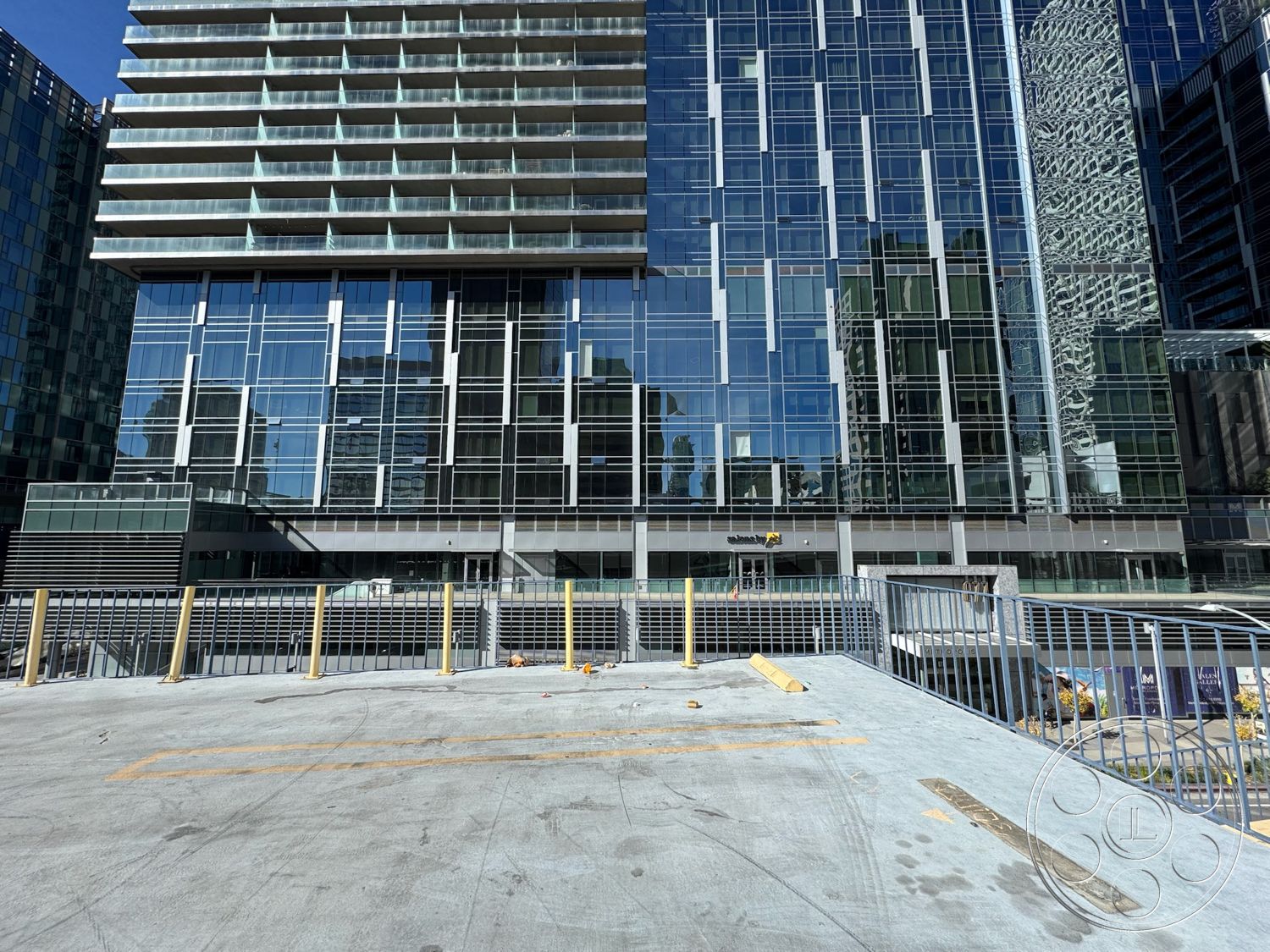 Rooftop 6 - floor-to-ceiling windows, modern architectural style, urban skyline view, open-air terrace, exterior glass curtain wall, horizontal concrete slabs, concrete plaza flooring, steel railing balcony, textured concrete parking deck, rectangular high-rise building, multifamily residential design, reflected glass facade, metal awnings, gated entrance patio, commercial mixed-use development