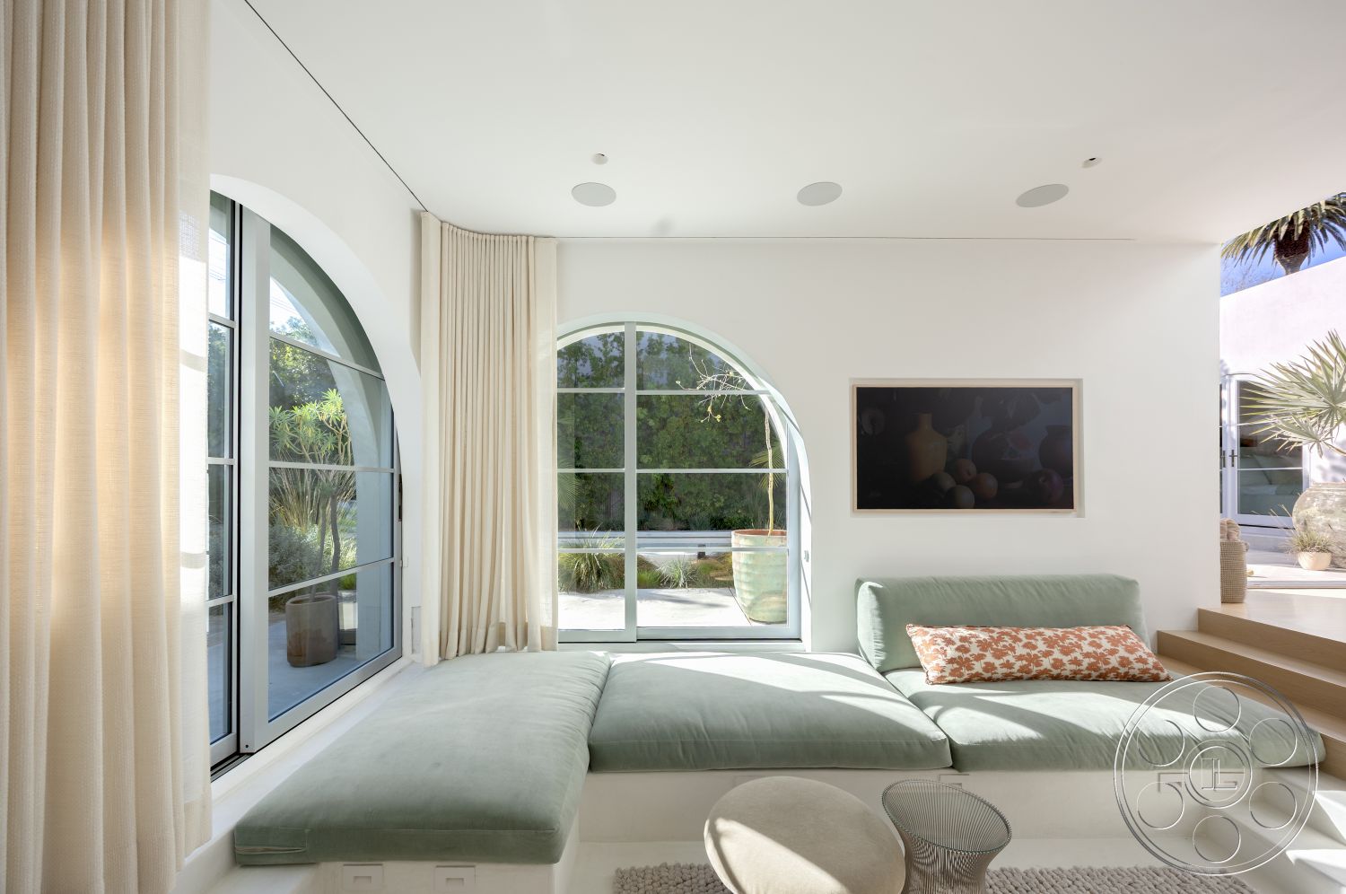 Modern 519 - minimalist decor, soft neutral color palette, floor-to-ceiling windows, contemporary design elements, open concept living space, smooth white walls, textured ceiling details, natural plant accents, indoor greenery view, arched window frames, light beige fabric curtains, soft green upholstered bench, concealed lighting, inviting relaxation area