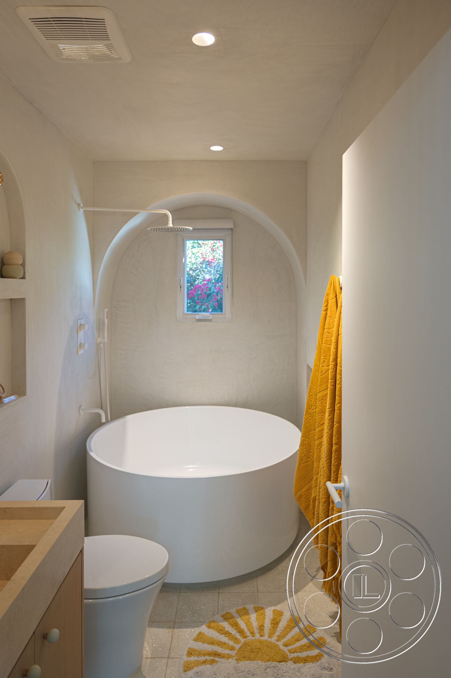 Modern 519 - textured plaster walls, interior bathroom design, modern recessed lighting, white wall paint, wood vanity with natural finish, minimalist toilet design, round freestanding bathtub, modern tile bathroom flooring, decorative yellow bath towel, arched shower alcove, cooktop sink area, sun-themed bathroom rug