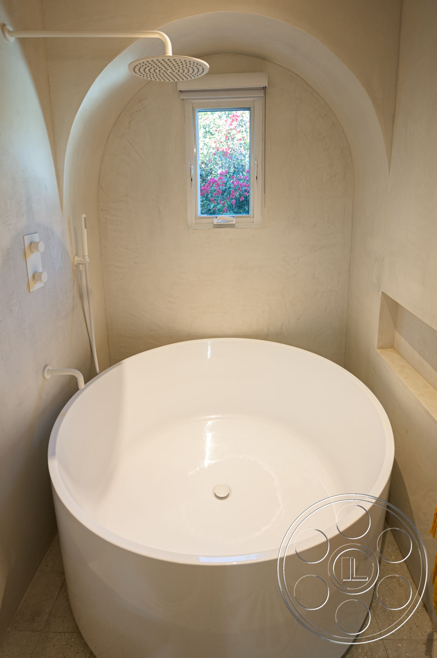 Modern 519 - neutral color palette interior, textured plaster ceiling, clean lines architecture, minimalist bathroom design, exposed plaster bathroom walls, rectangular shower area, stone tile bathroom flooring, curved freestanding bathtub, modern rain shower head, contemporary bathroom lighting, arched wall structure