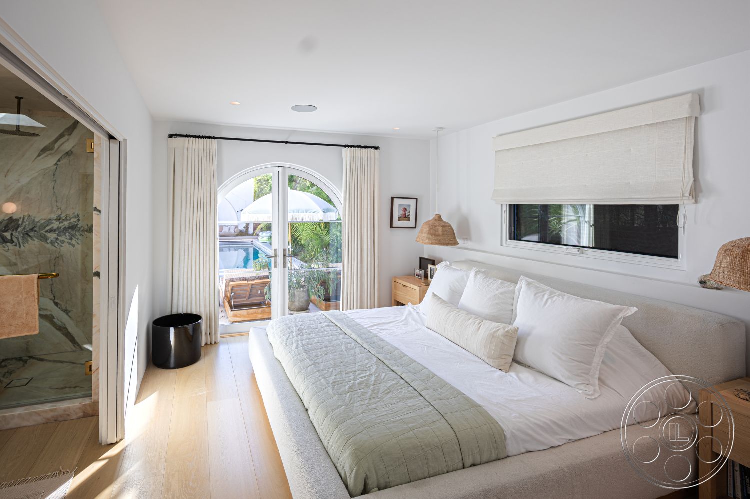 Modern 519 - neutral color palette, floor-to-ceiling windows, arched doorway, modern minimalist decor, glass shower doors, natural light interior, hardwood bedroom floors, white painted walls, luxury master bedroom, stylish accent decor, outdoor balcony access, contemporary bedside tables, modern decorative lighting, textured fabric window treatments, stone tile bathroom walls, interior with poolside view