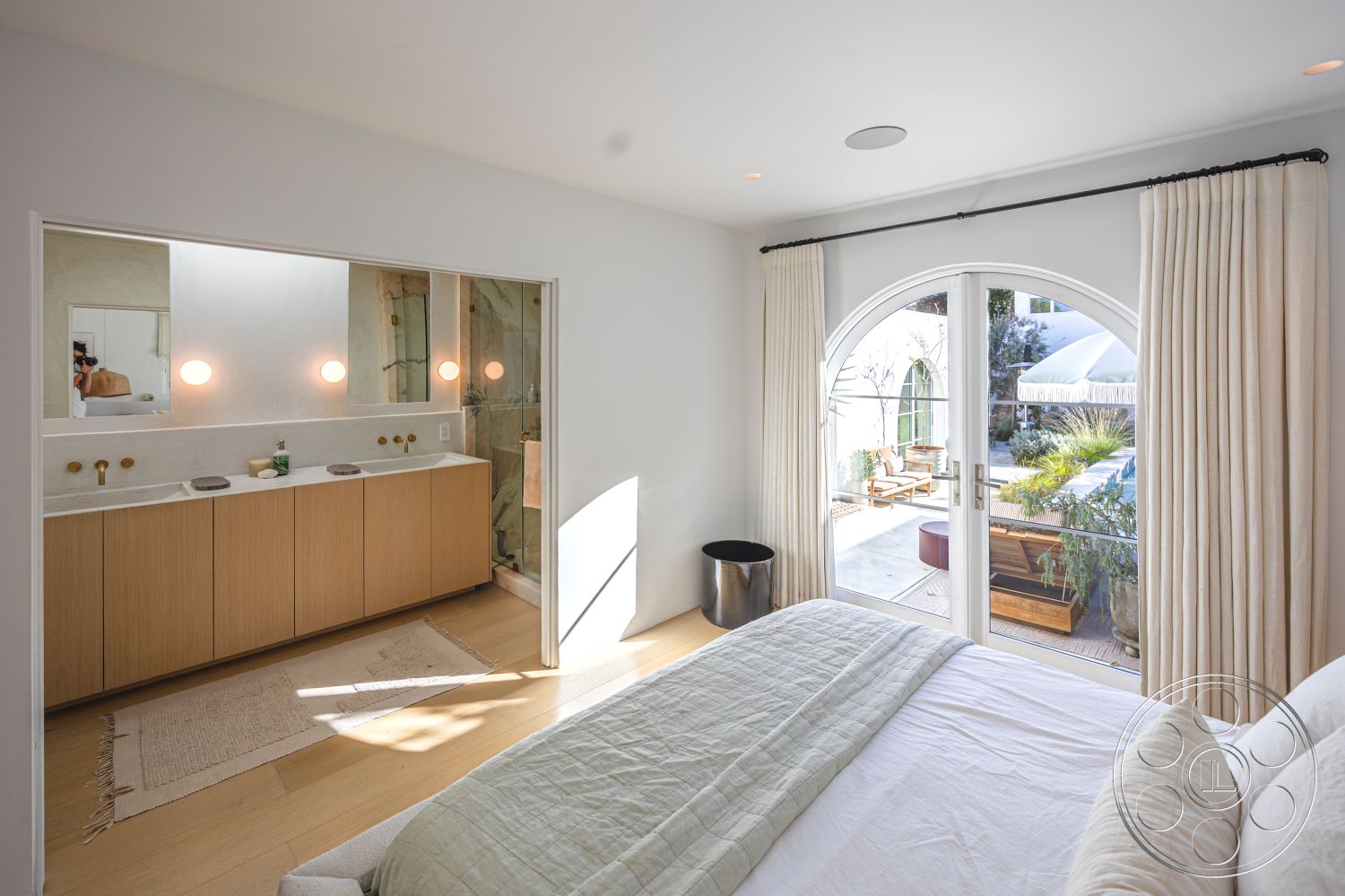 Modern 519 - neutral color palette, glass shower enclosure, outdoor patio space, light wood cabinetry, white painted walls, minimalist interior design, hardwood bedroom floors, marble bathroom countertops, soft natural lighting, textured fabric curtains, modern bathroom fixtures, open-concept space, double sink bathroom vanity, arched interior doors