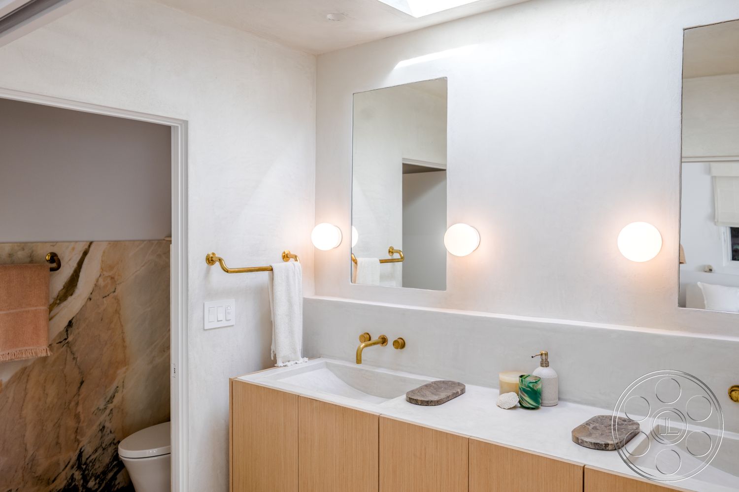 Modern 519 - neutral color palette, spa-like atmosphere, ceramic tile flooring, backlit mirrors, transitional style, soft natural lighting, textured plaster walls, marble accent wall, modern minimalist design, interior bathroom, open floor plan design, skylight ceiling, luxurious bathroom setting, hardwood bathroom vanity, golden brass fixtures, floating bathroom sinks, elegant towel bar, decorative stone details