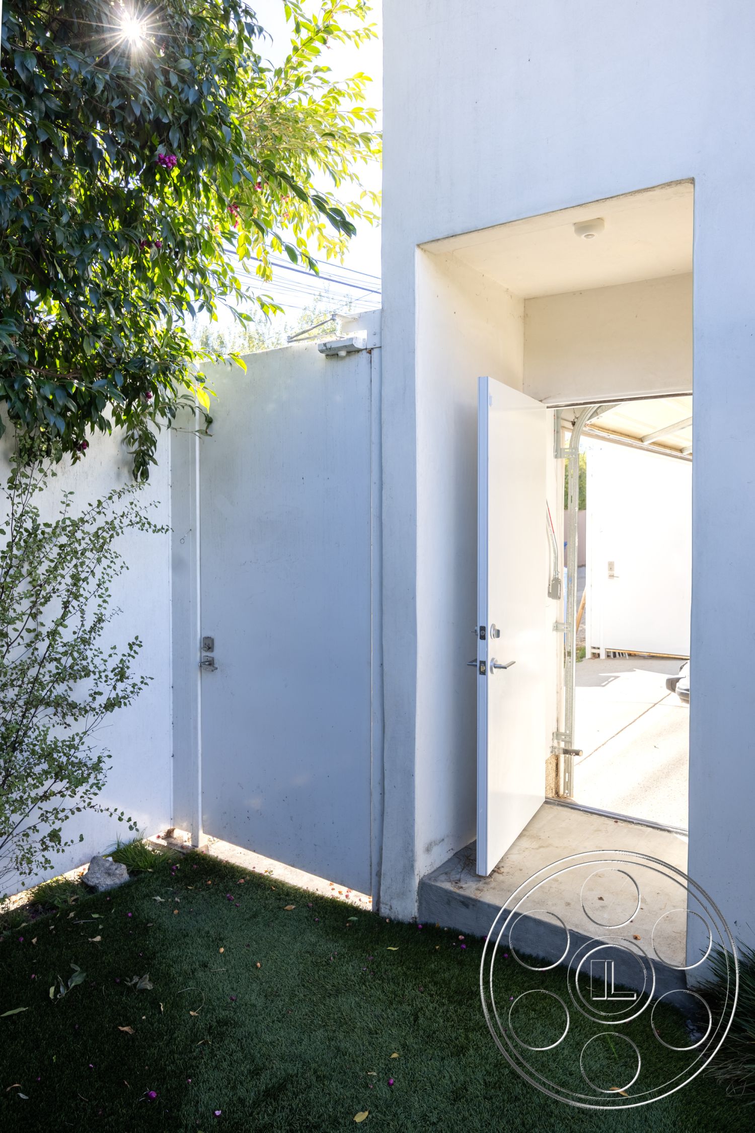 Modern 519 - natural light, exterior, landscaped garden, clean lines, outdoor space, modern design, concrete walls, metal gate, sliding glass door, monochromatic color scheme, residential setting, artificial turf lawn, minimalist architecture, open entryway, simple geometric forms, vertical garden elements, concrete step landing