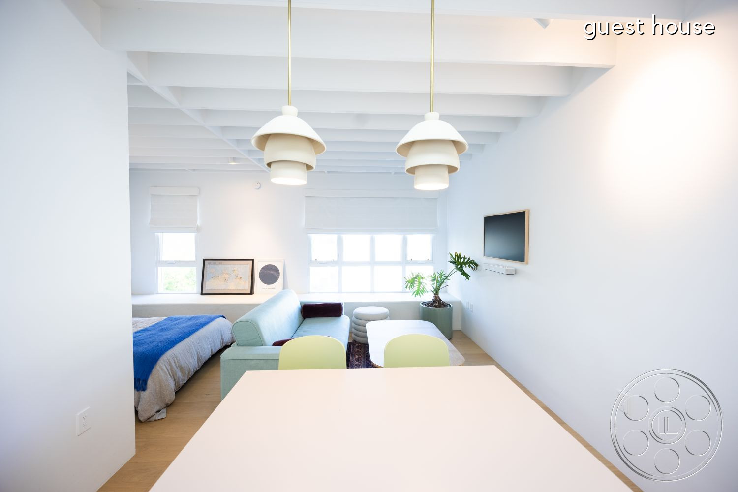 Modern 519 - white painted walls interior, indoor plant decor interior, wood beam ceiling interior, modern pendant lighting interior, minimalist decor interior, light hardwood flooring interior, green accent chair interior, open-concept living space interior, contemporary dining table interior, casual seating area interior, soft fabric sofa interior, large windows providing natural light interior, wall-mounted TV unit interior, art frames on walls interior