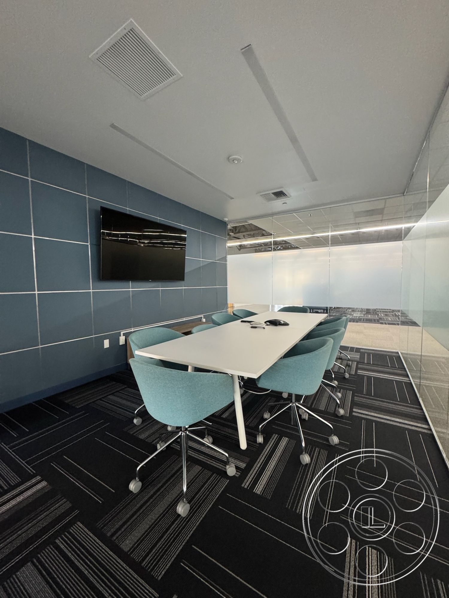 Office 128 - neutral color palette, collaborative workspace, glass partition walls, acoustic ceiling panels, interior office space, modern conference table, ergonomic office furniture, minimalist office design, linear LED ceiling lights, flat-screen wall-mounted TV, upholstered swivel chairs, blue painted accent wall, dark patterned carpet tiles, rectangular meeting room layout, open floor plan office