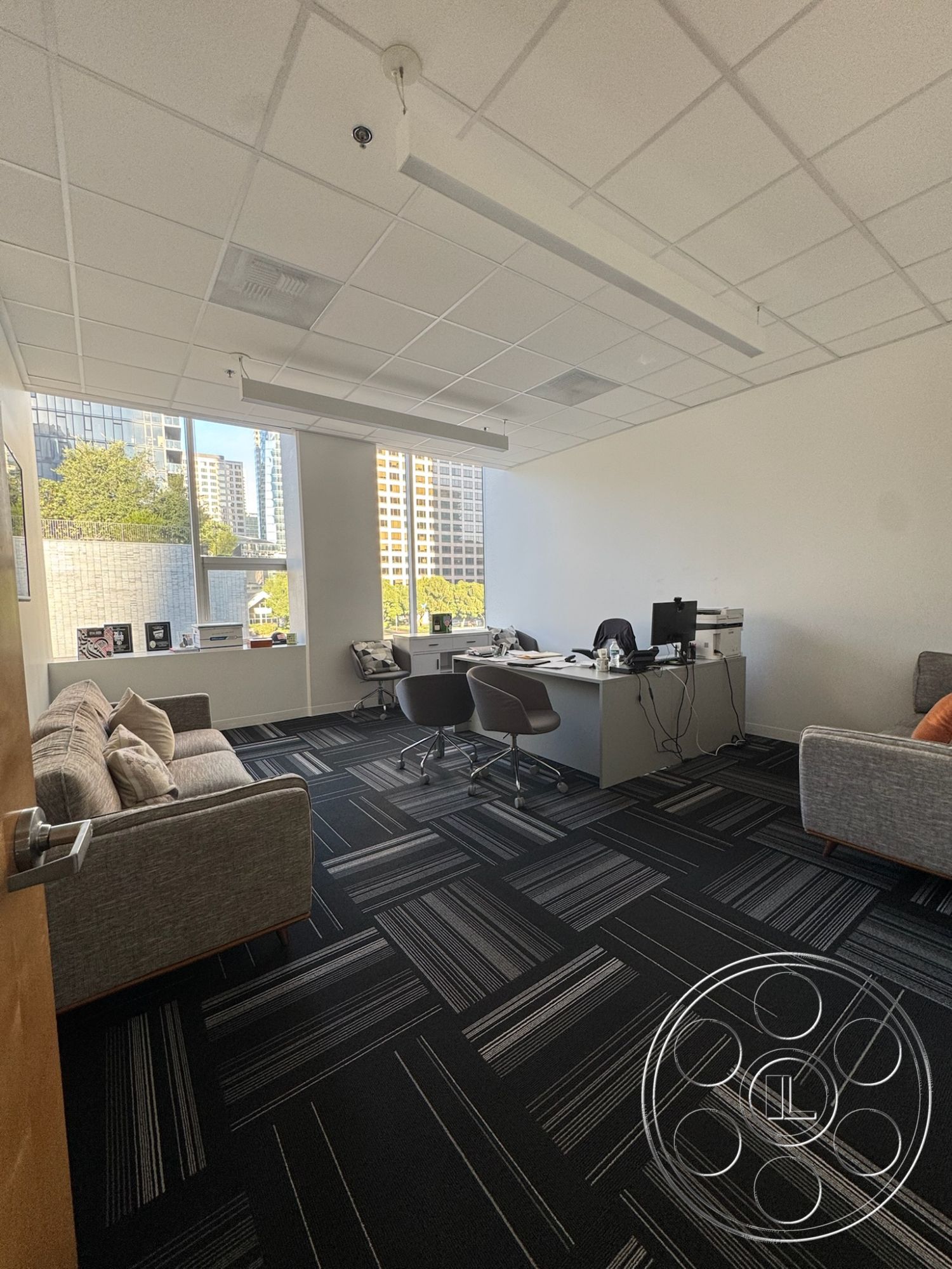 Office 128 - minimalist decor, natural light, contemporary furniture, functional workspace, plush fabric sofa, ergonomic office chairs, acoustic ceiling tiles, open layout design, urban office environment, interior office space, large windows with city view, modern office desk, workspace with computer setup, black and white striped carpet flooring, paperwork and stationery organization