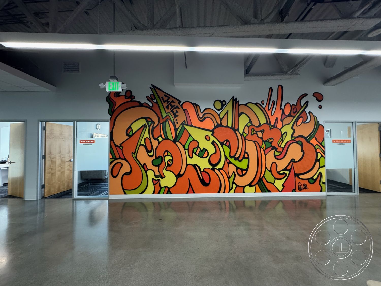 Office 128 - minimalist aesthetic, open floor plan, polished concrete flooring, glass partition walls, modern office space, industrial style design, exposed steel ceiling beams, interior graffiti accent wall, colorful contemporary mural