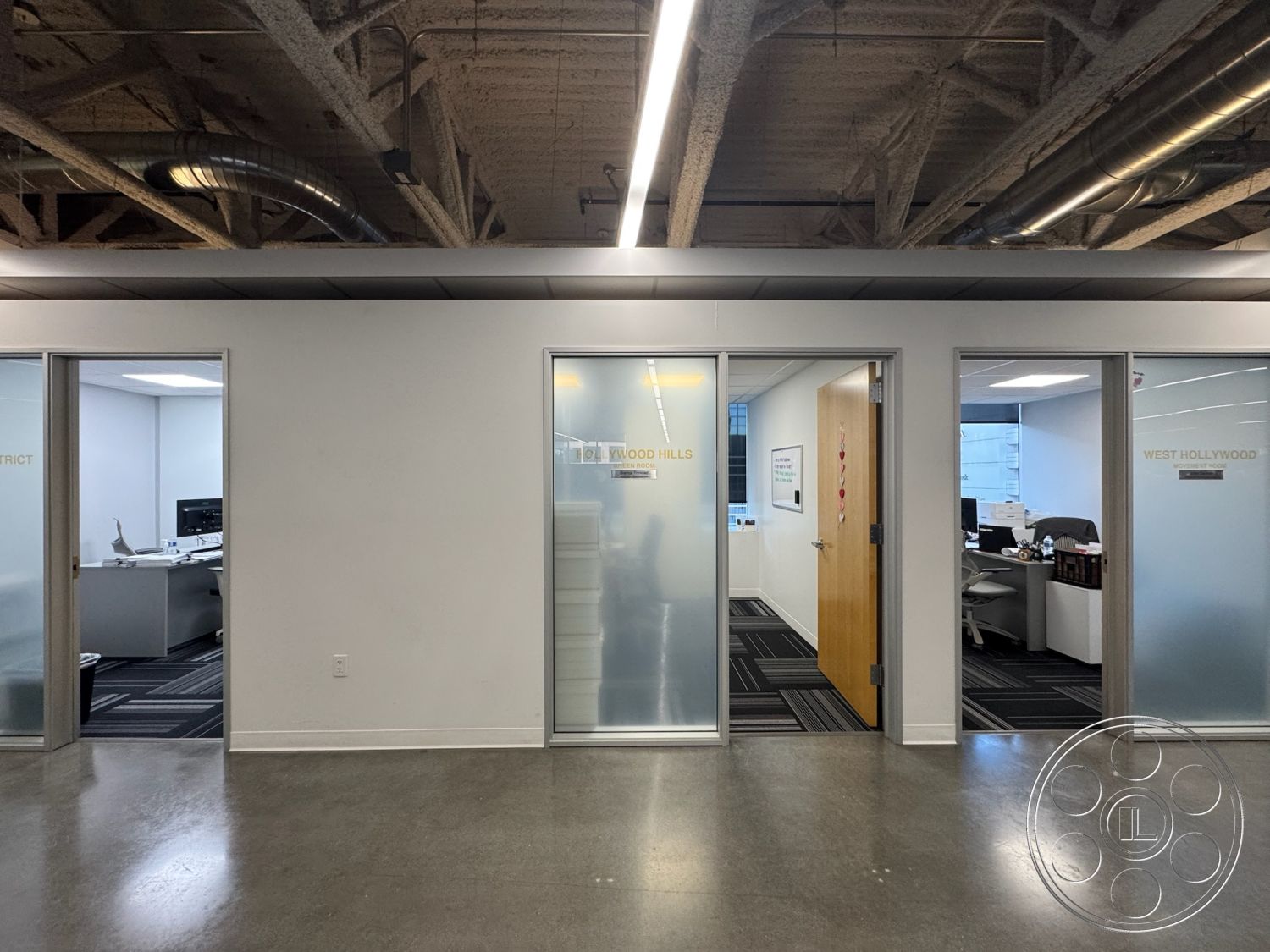 Office 128 - polished concrete flooring, floor-to-ceiling windows, open floor plan layout, minimalist interior decor, commercial space environment, contemporary office design, exposed ductwork ceiling, urban office setting, striped carpet tiles, rectangular office layout, neutral painted interior walls, industrial style lighting fixtures, glass entry doors, glass office partition walls, acoustic tile ceiling panels, modern wooden door frames, traditional office workspace, private meeting rooms, collaborative working areas, efficient workspace function