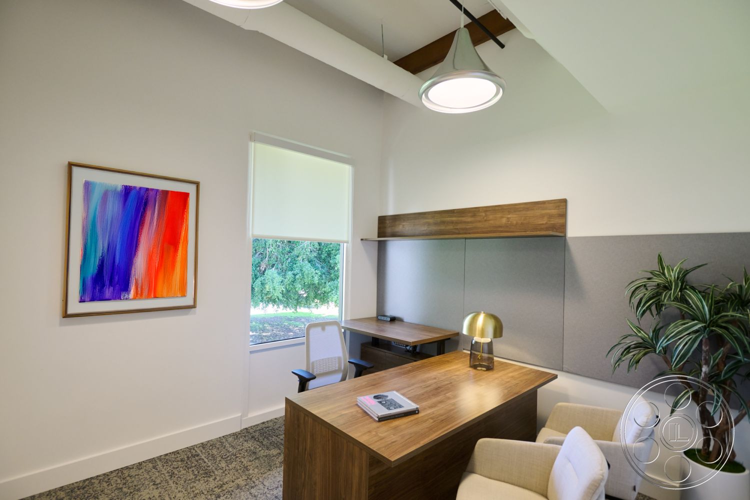 Office 129 - neutral color palette, polished concrete flooring, soft natural lighting, minimalist office chair, modern home office, colorful abstract wall art, textured gray wall paneling, wooden desk with natural finish, ceiling-mounted industrial pendant light, large window with view of greenery, built-in shelving above desk, indoor potted plant accent