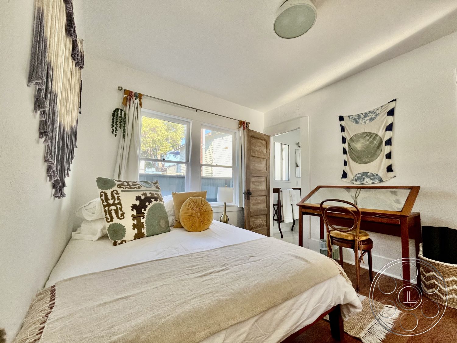 Craftsman 56 - wooden door, textured throw blanket, natural light from windows, decorative throw pillows, cozy reading nook, woven storage basket, modern rustic design, hardwood bedroom floors, white painted walls, contemporary wall art, bright and airy interior, macrame wall hanging, minimalist desk space, curved floor lamp, simple decorative elements, small home office setup, natural fiber textiles, functional yet aesthetic space