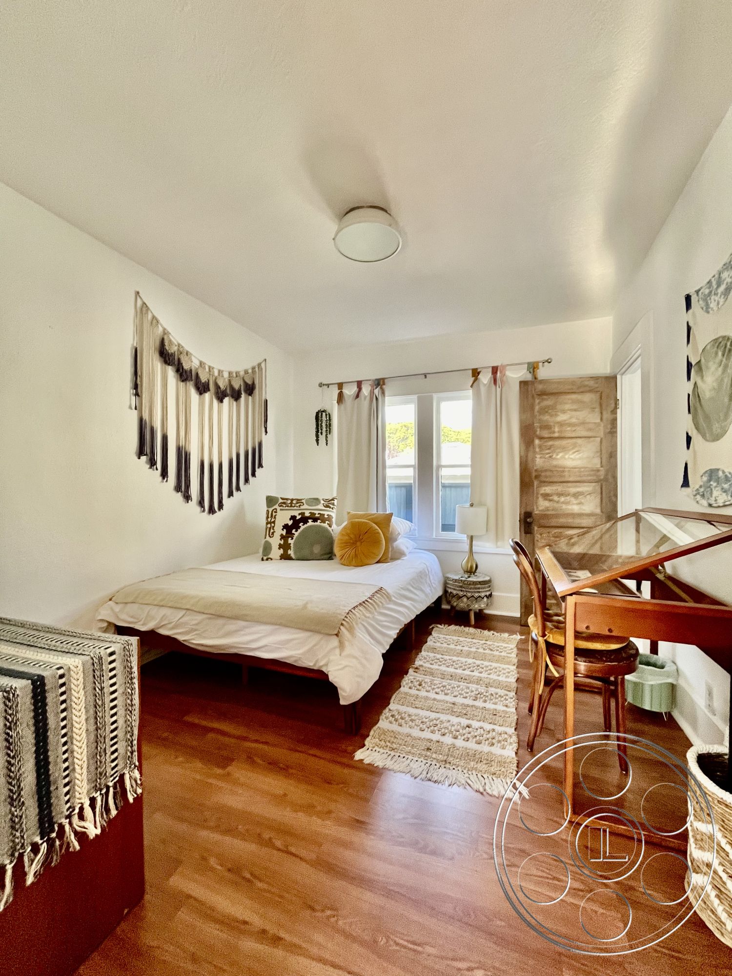 Craftsman 56 - textured area rug, wooden door, decorative throw pillows, modern table lamp, scandinavian design elements, glass window treatments, natural light interior, hardwood bedroom floors, white painted walls, cozy master bedroom, woven textile wall hanging, minimalist writing desk