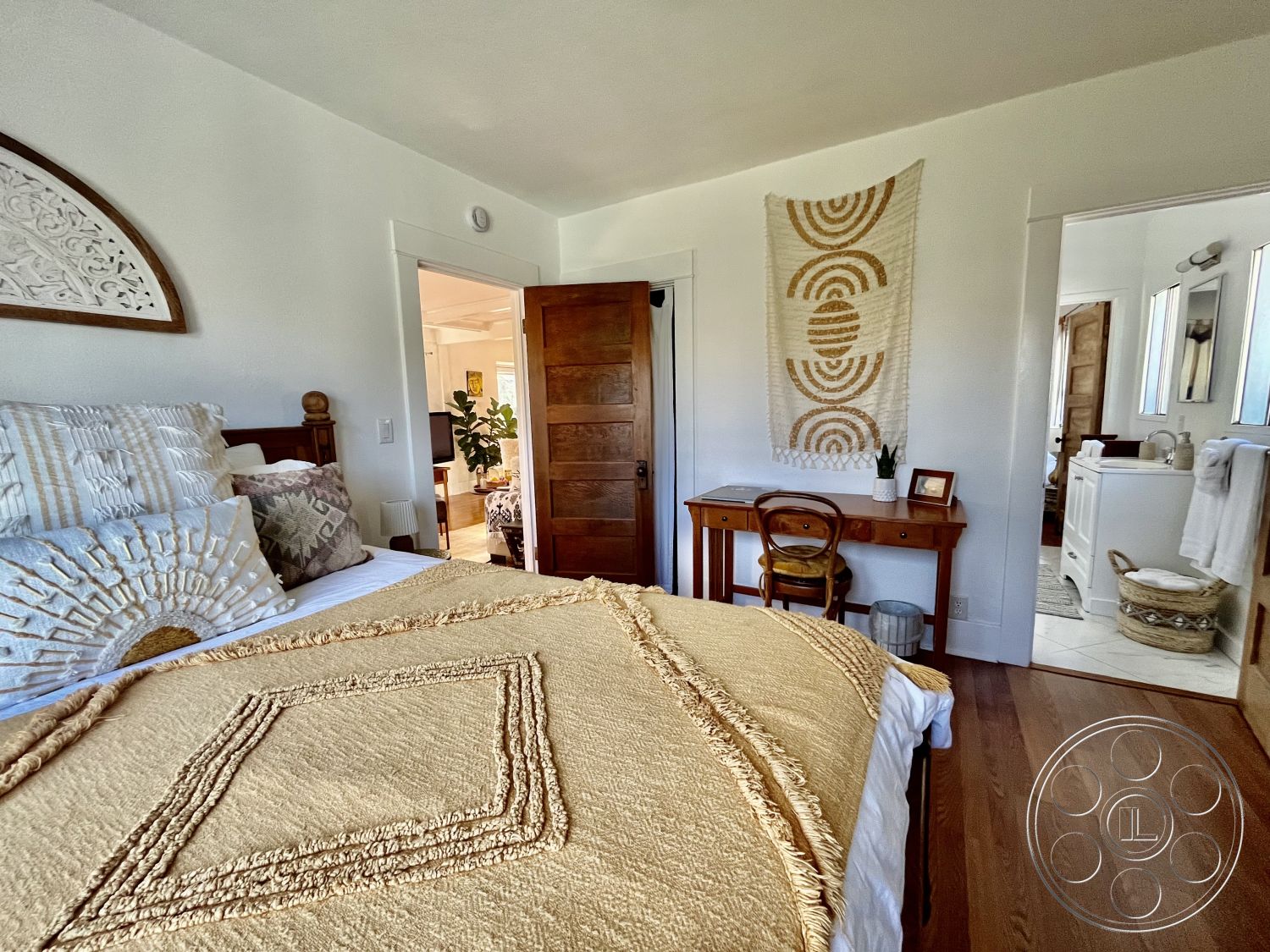 Craftsman 56 - neutral color palette, cozy atmosphere, plant decor, open concept layout, wooden door, textured throw blanket, master bedroom, modern rustic style, natural light from windows, soft lighting fixtures, woven wall hanging, modern minimalist aesthetic, hardwood bedroom floors, white painted walls, decorative pillows with geometric patterns, side table with natural wood finish