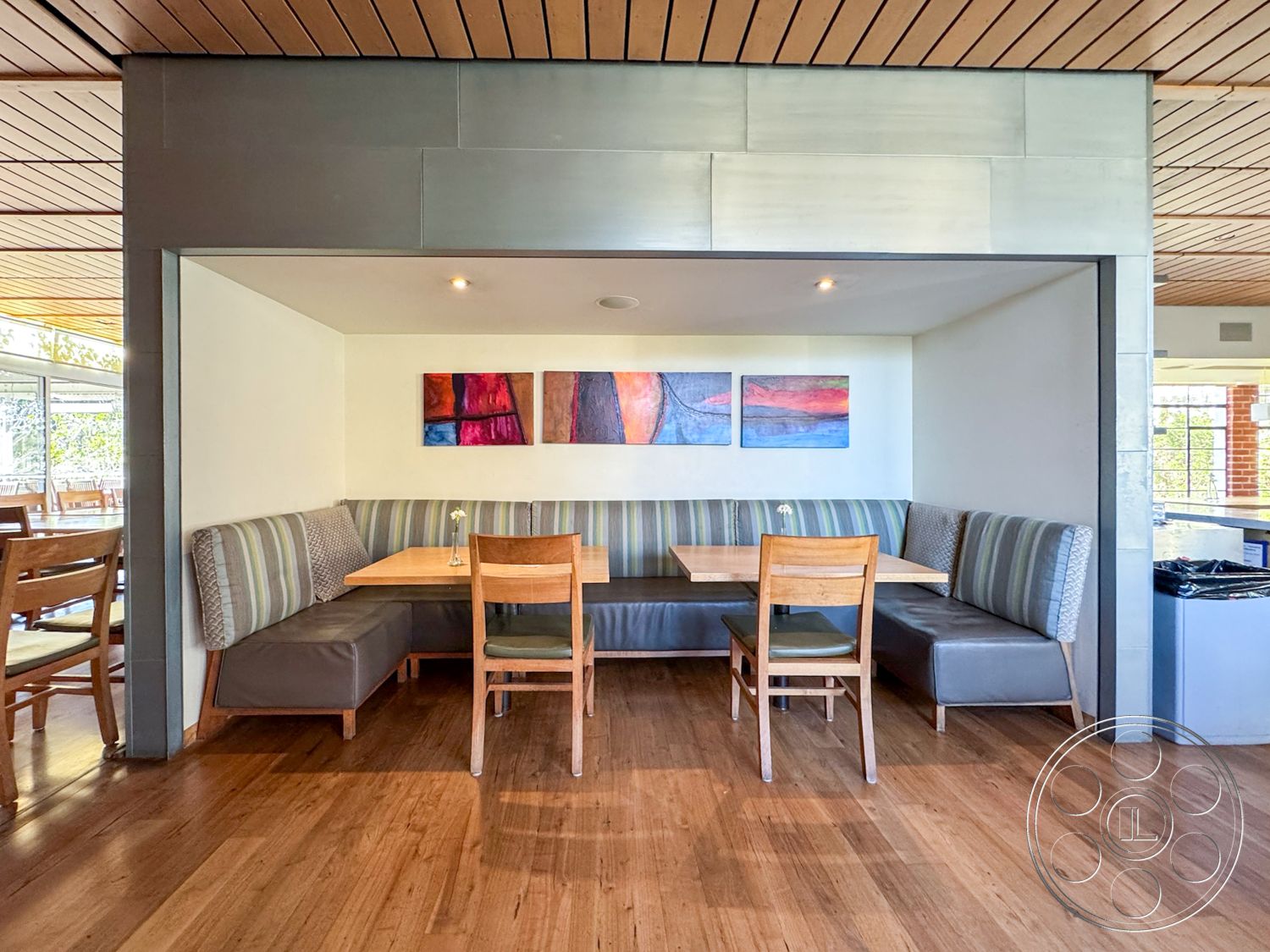 Adams Mansion - interior white painted walls, interior minimalist design elements, interior hardwood dining room floors, interior wood panel ceiling, interior booth seating with gray upholstery, interior rectangular wooden dining table, interior artwork wall decor, interior booth dining area, interior built-in bench seating, interior light fixtures recessed in ceiling, interior contemporary dining space, interior modern seating arrangement