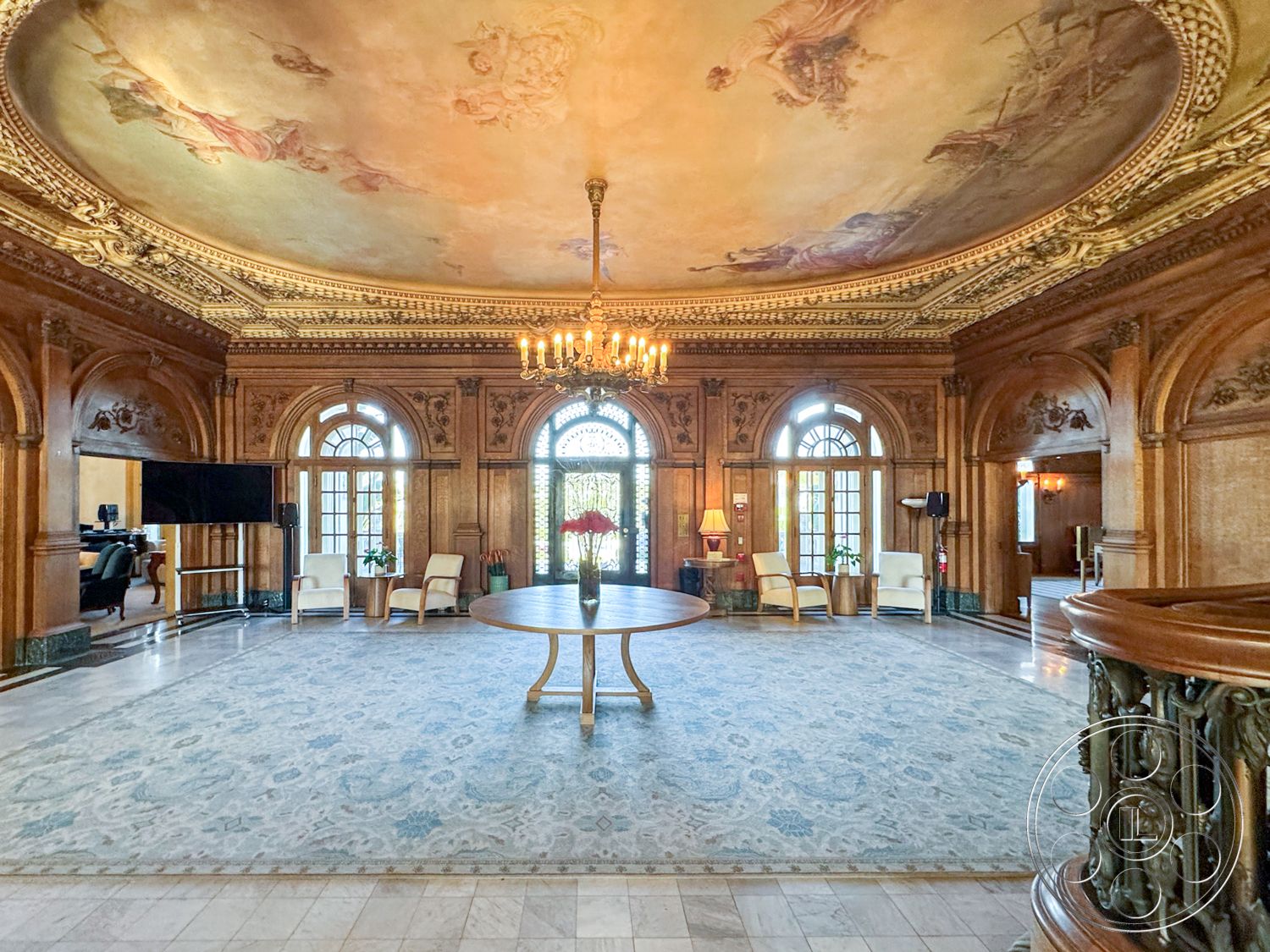 Adams Mansion - textured area rug, symmetrical layout, classic architectural style, interior wood paneling, stately entryway, exposed wooden ceiling beams, intricate chandelier lighting, glass double doors, interior marble flooring, decorative crown molding details, vibrant floral arrangements, interior antique furnishings, interior coffered ceiling with ornate detailing, ornate ceiling fresco, elegant circular table, window with arched top, luxurious sitting area, plush seating arrangement, detailed door trim, interior wall paneling with carved details, high ceilings in public room